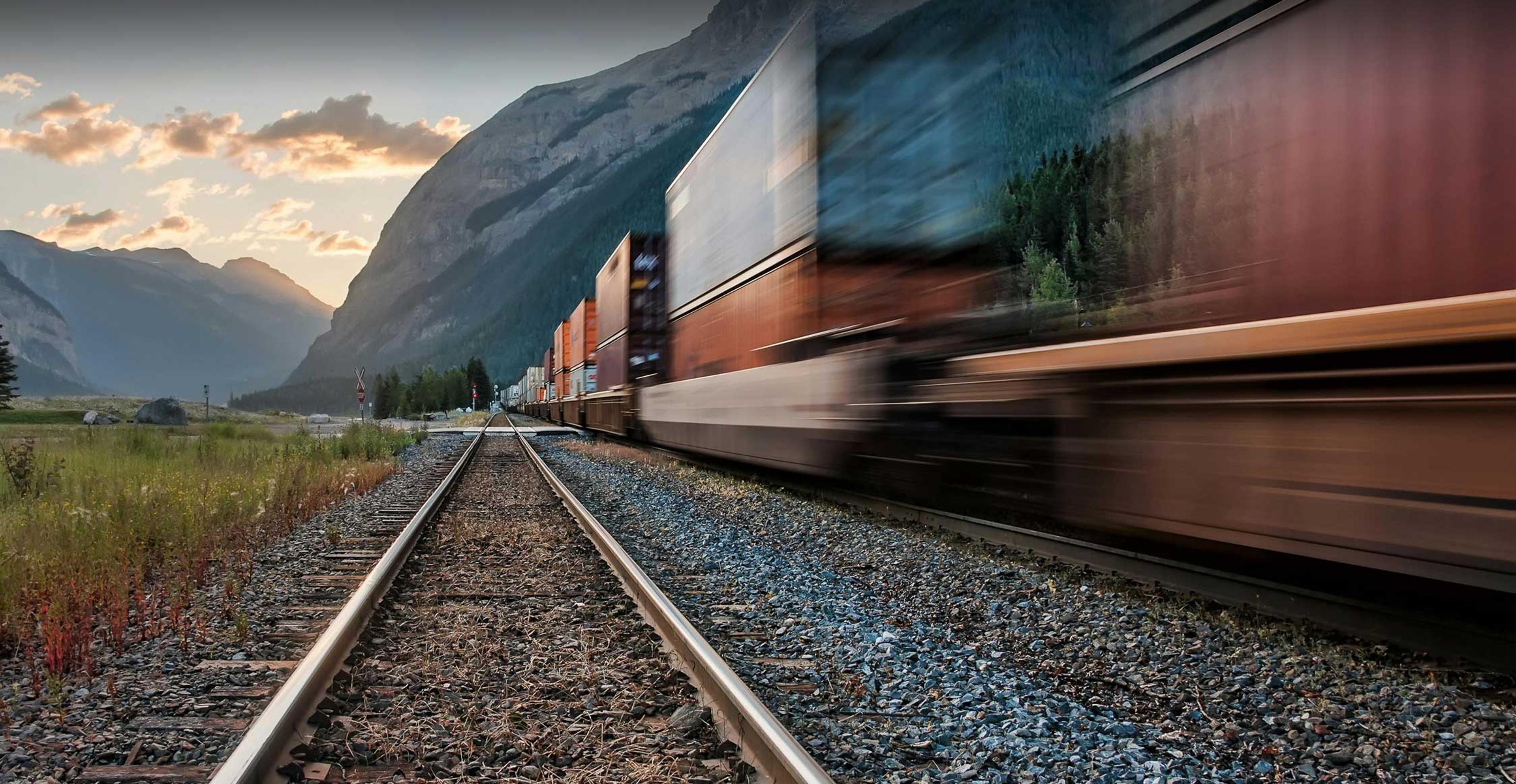 train full of cargo moving down the tracks