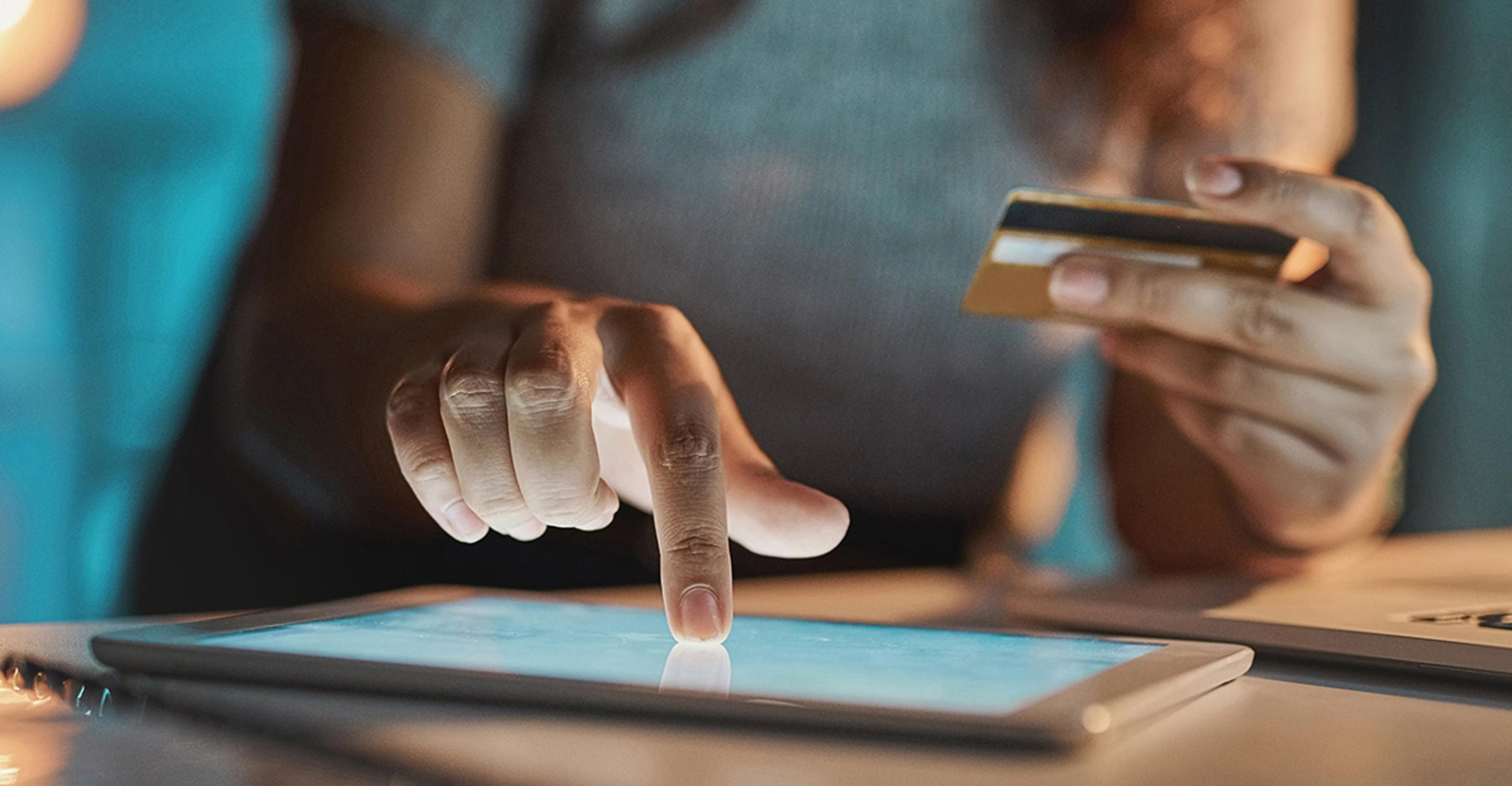 An online shopper entering credit card information into a tablet