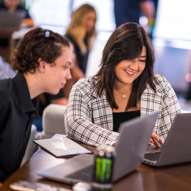 Two ITS Logistics team members happily working