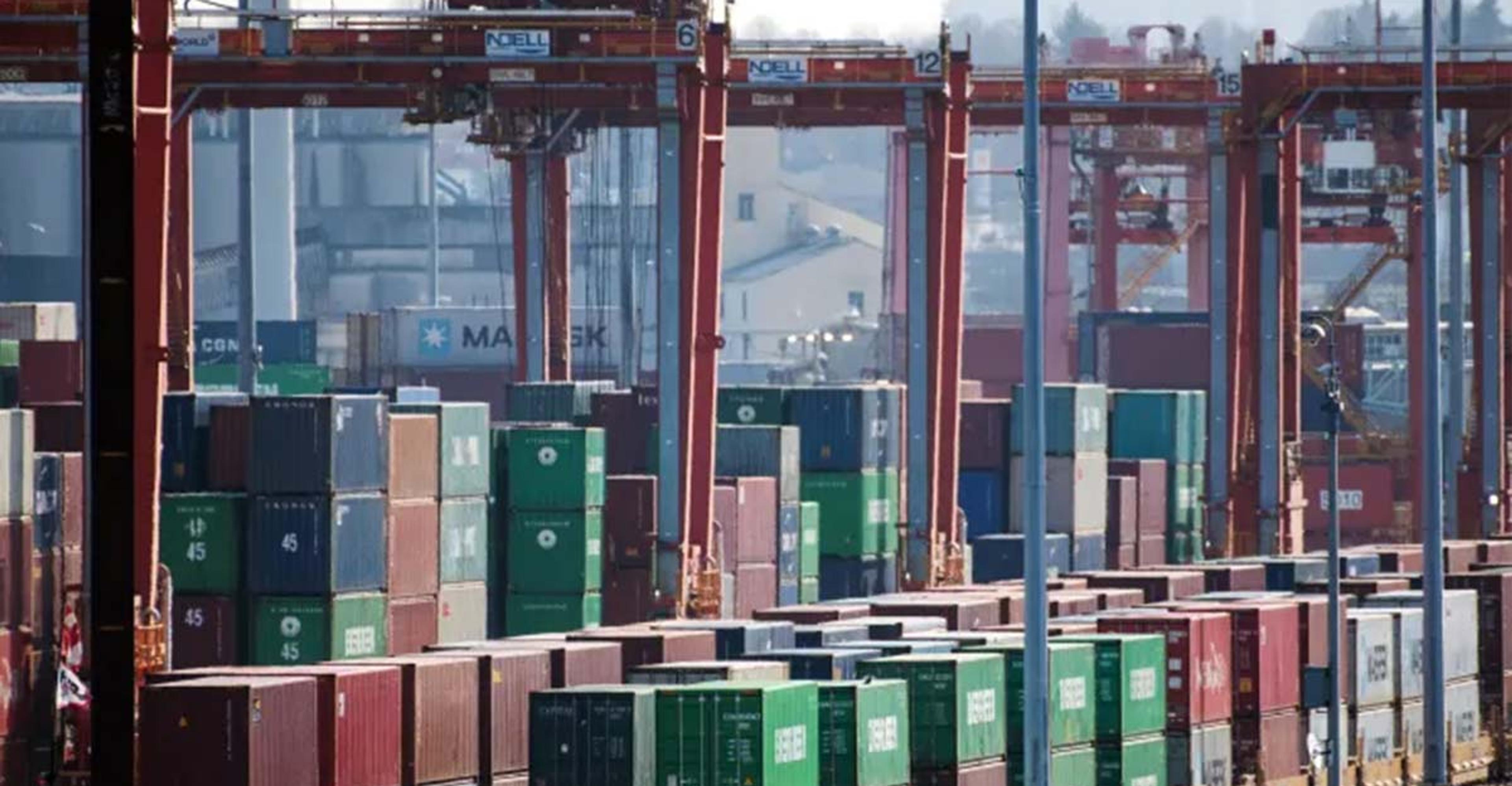stacks of containers in port and containers loaded onto flat cars
