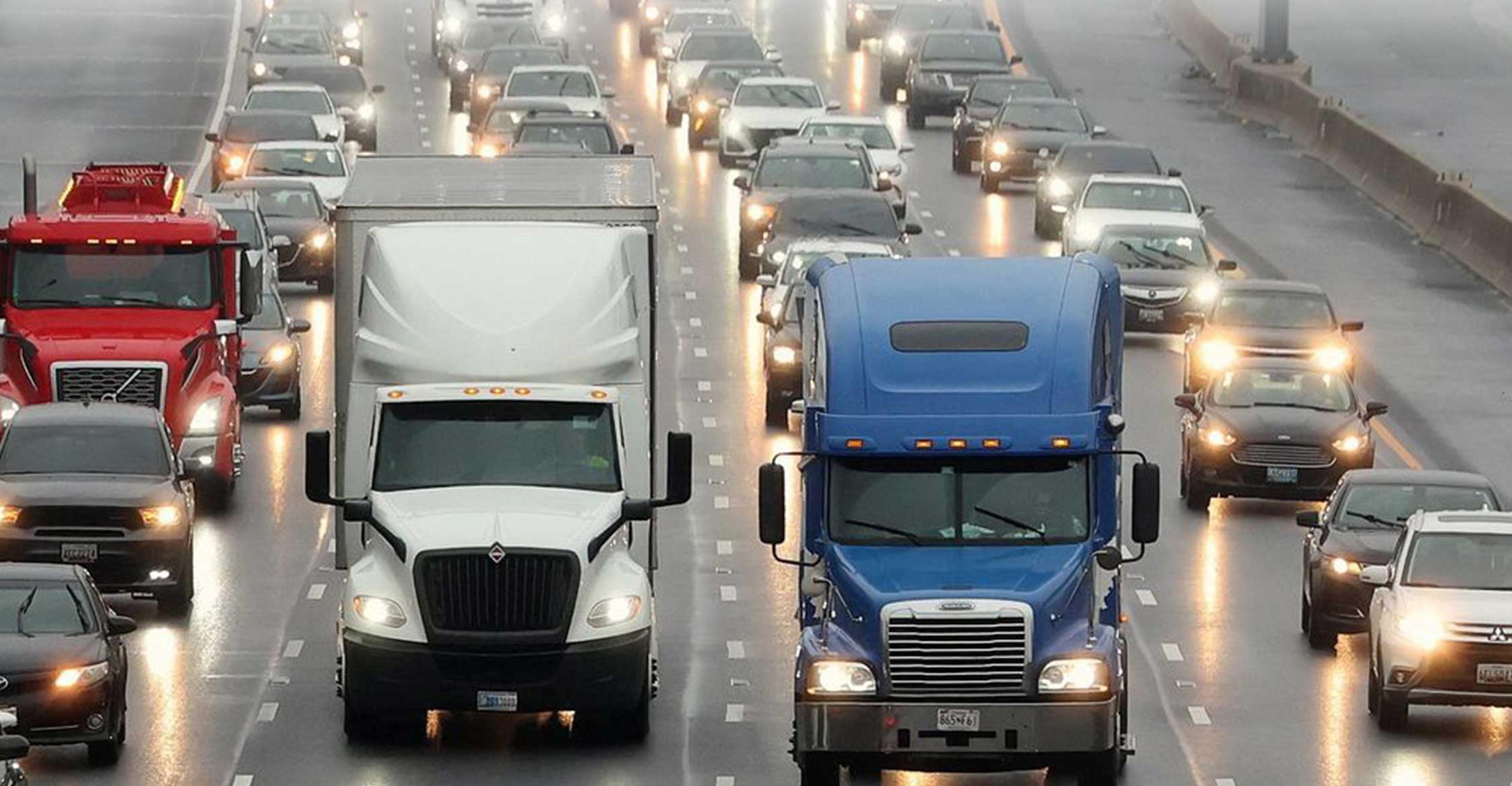 Semi trucks driving down the freeway.