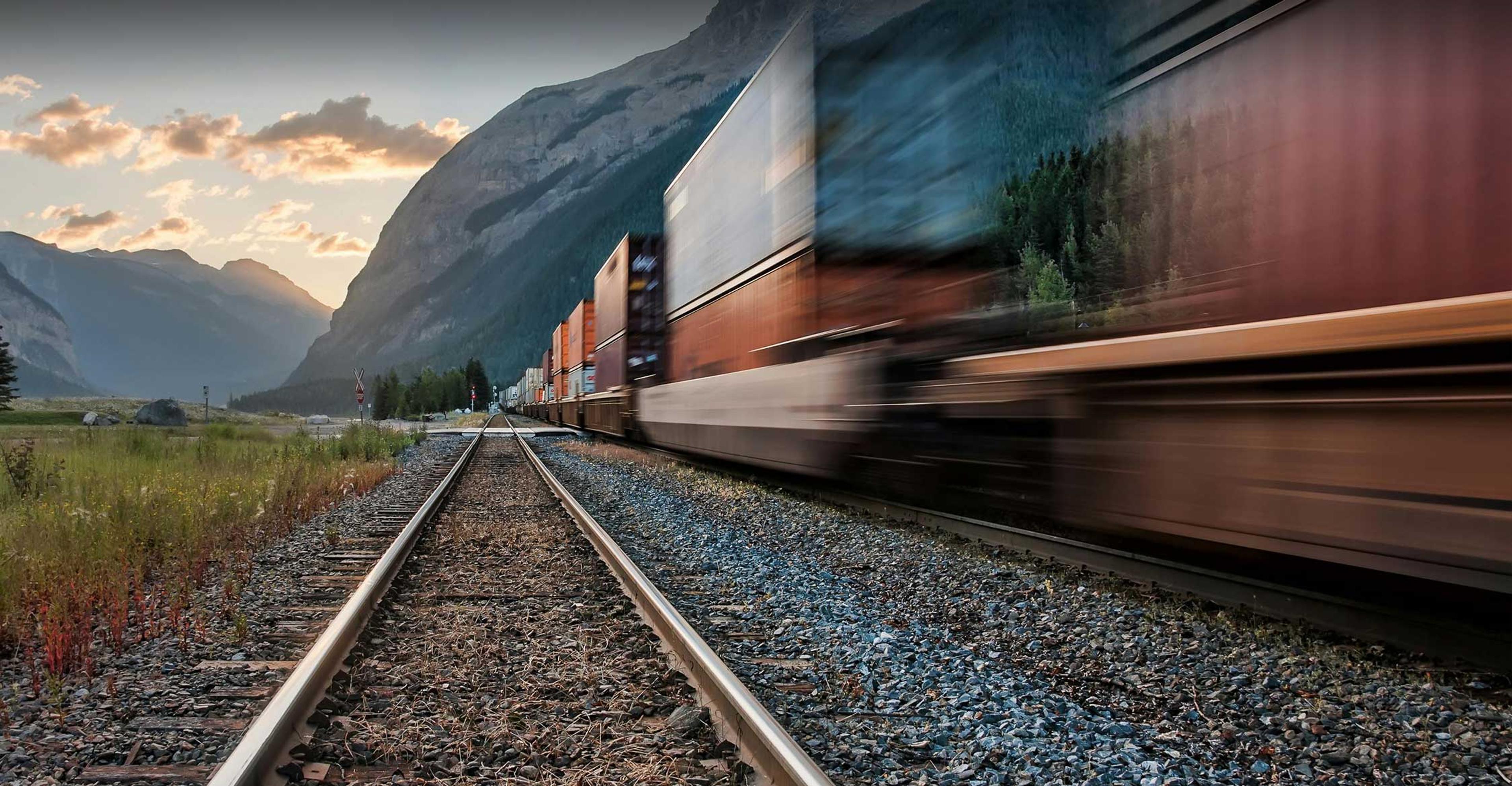 train full of cargo moving down the tracks