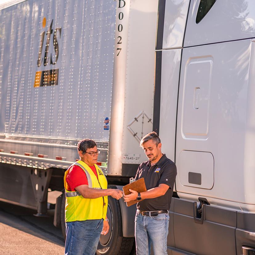 Two ITS fleet team members looking over paperwork