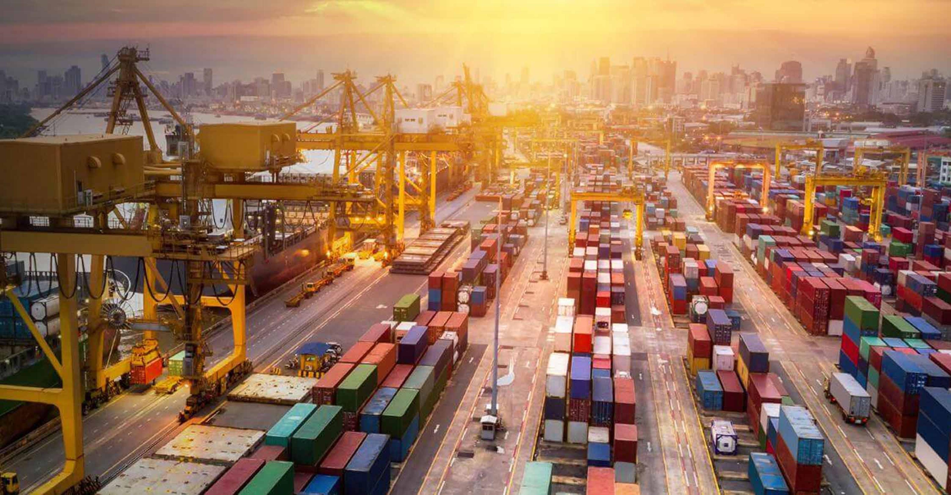 Ocean containers being loaded onto vessels in a port