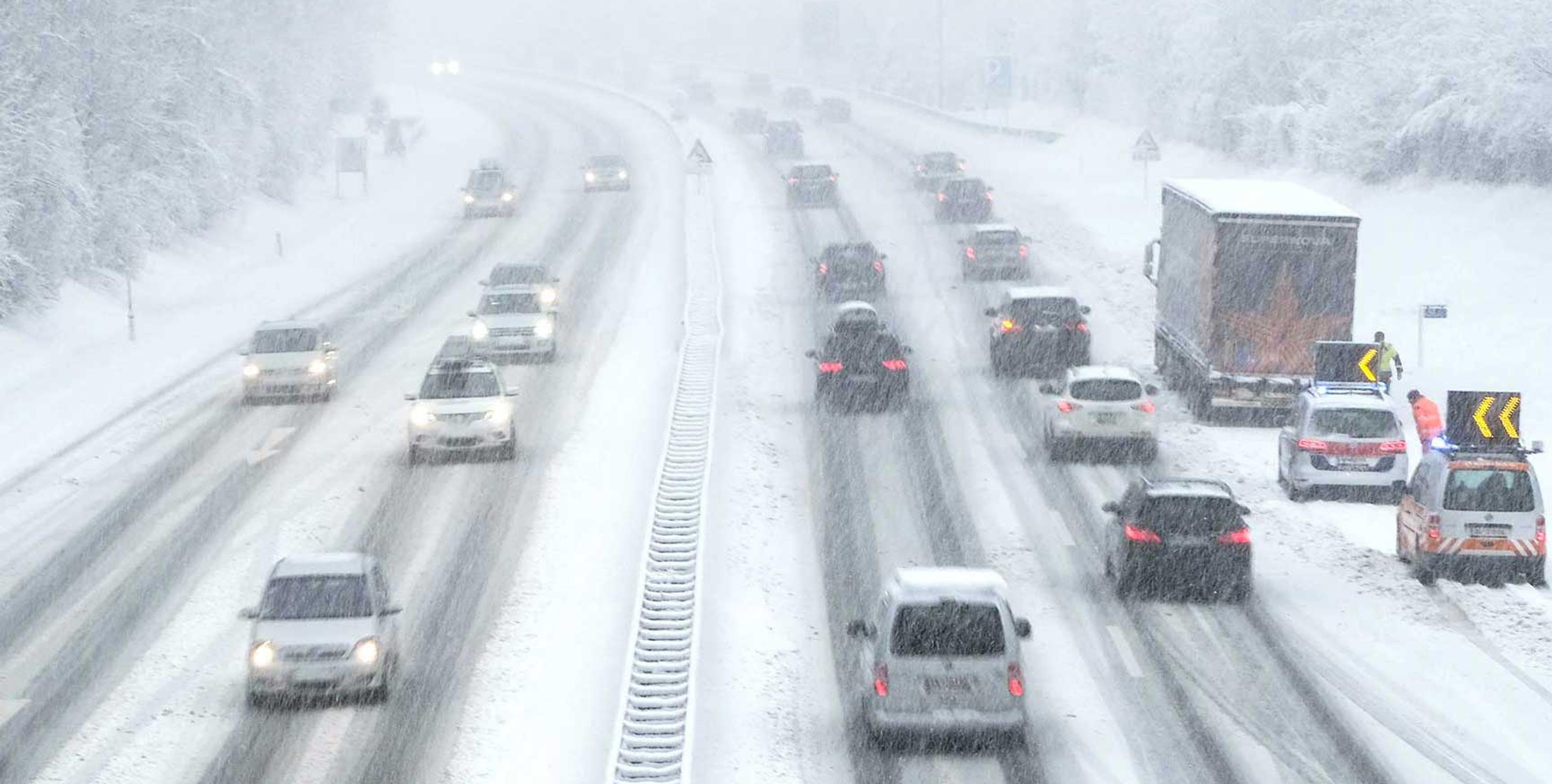 A busy, snow-covered freeway