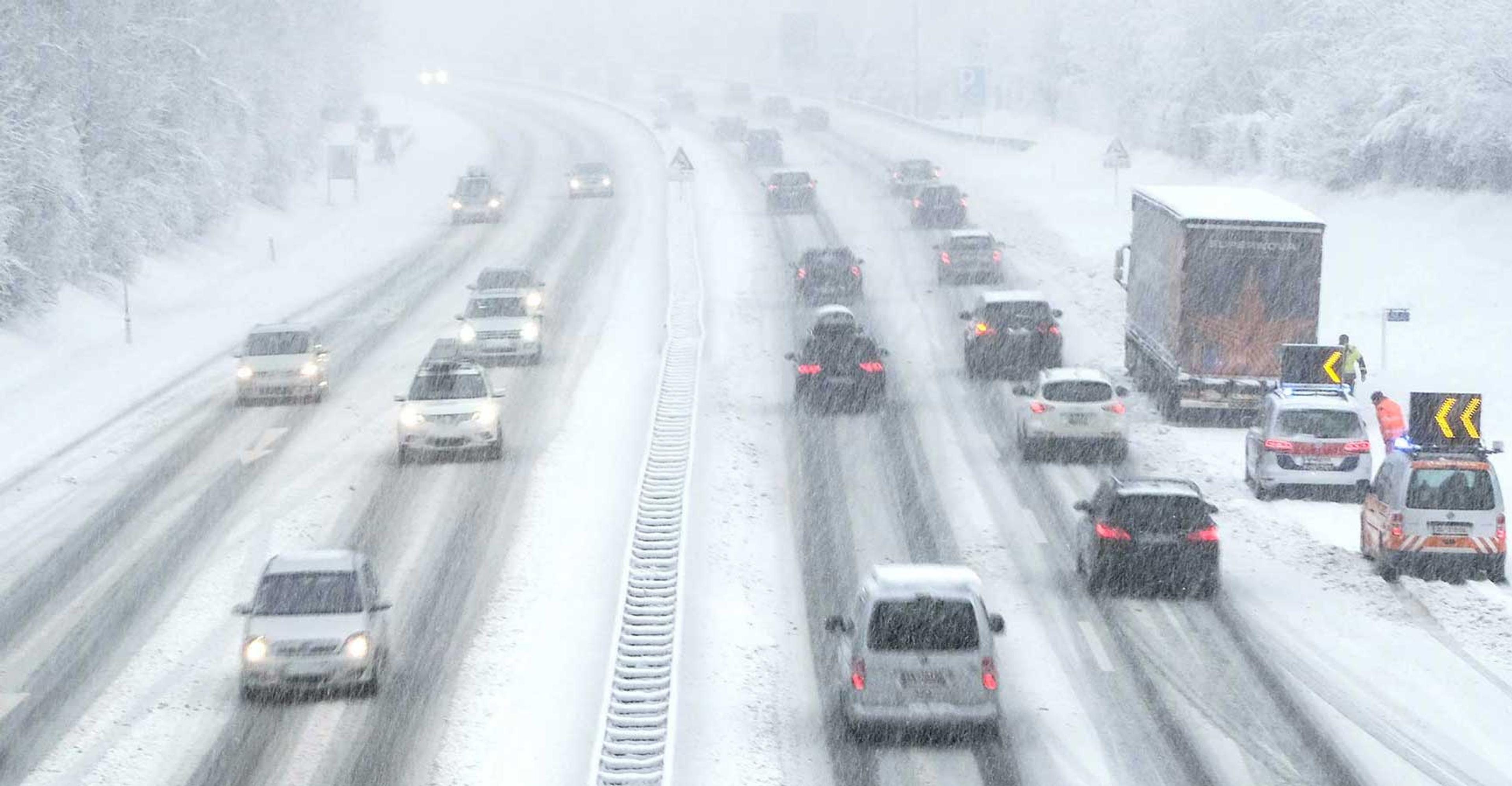 A busy, snow-covered freeway
