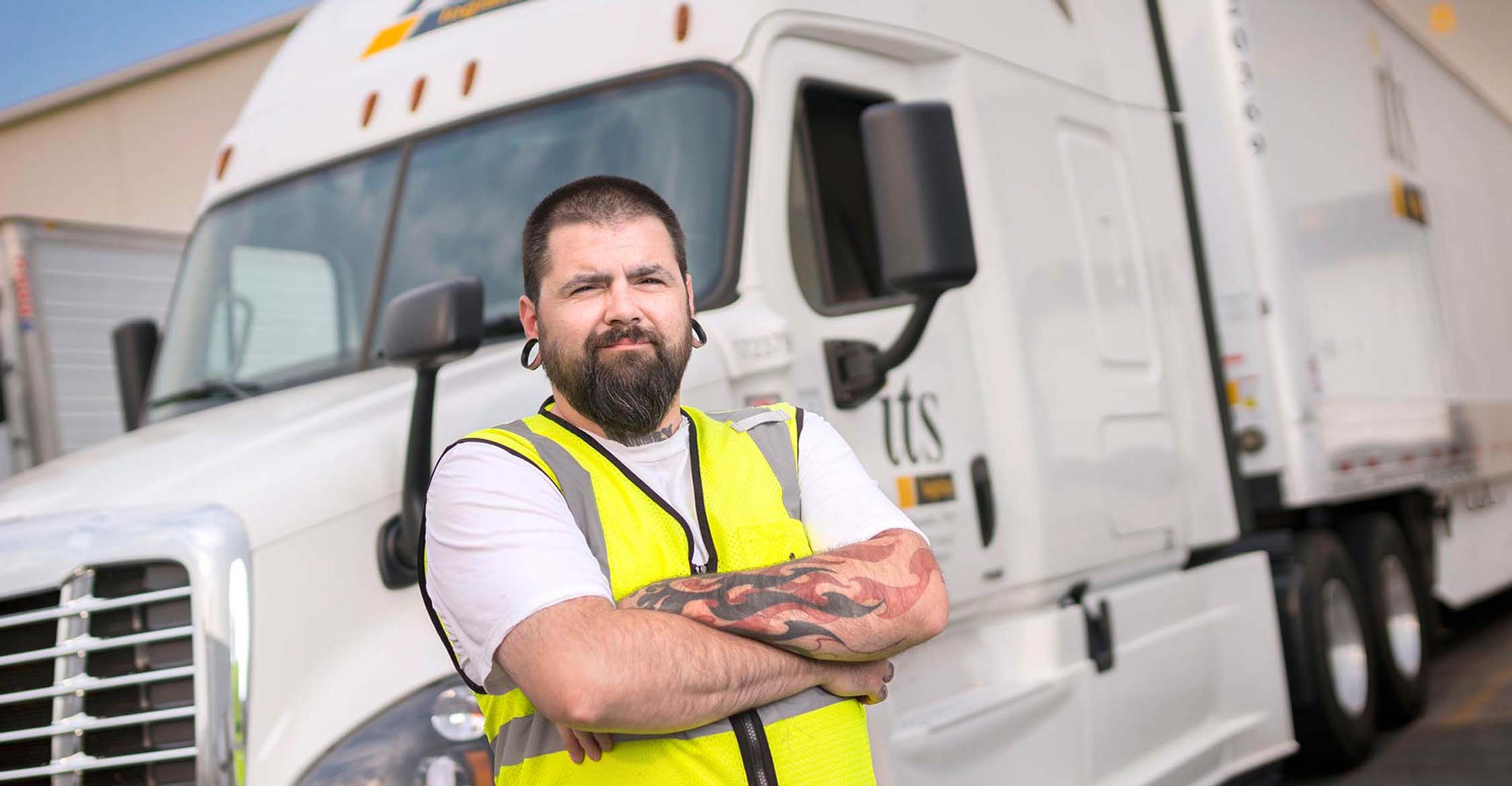 An ITS driver standing in front of a truck