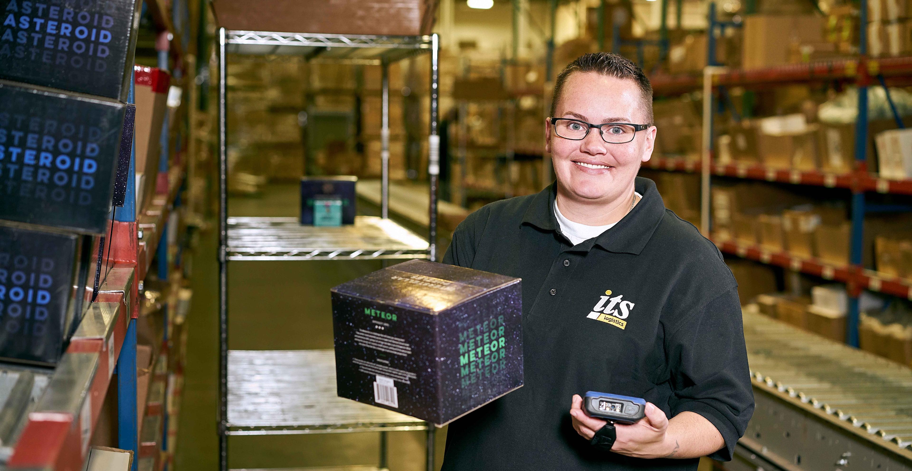 An ITS Logistics team member scanning an Uncommon Goods product in the warehouse