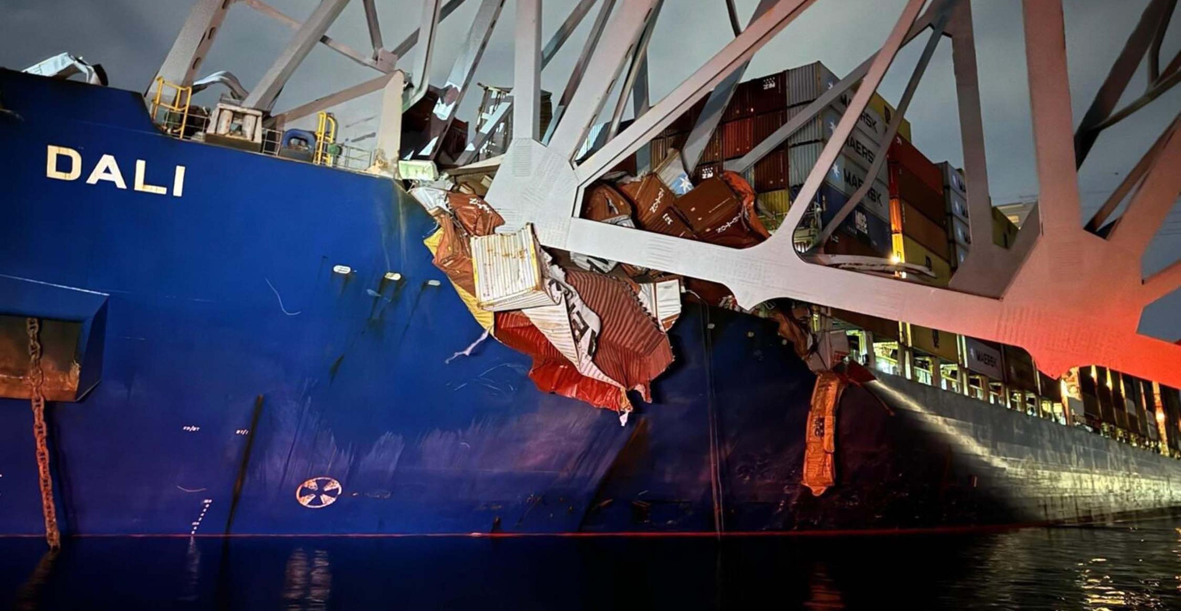 Collapsed Baltimore bridge on top of a blue container ship