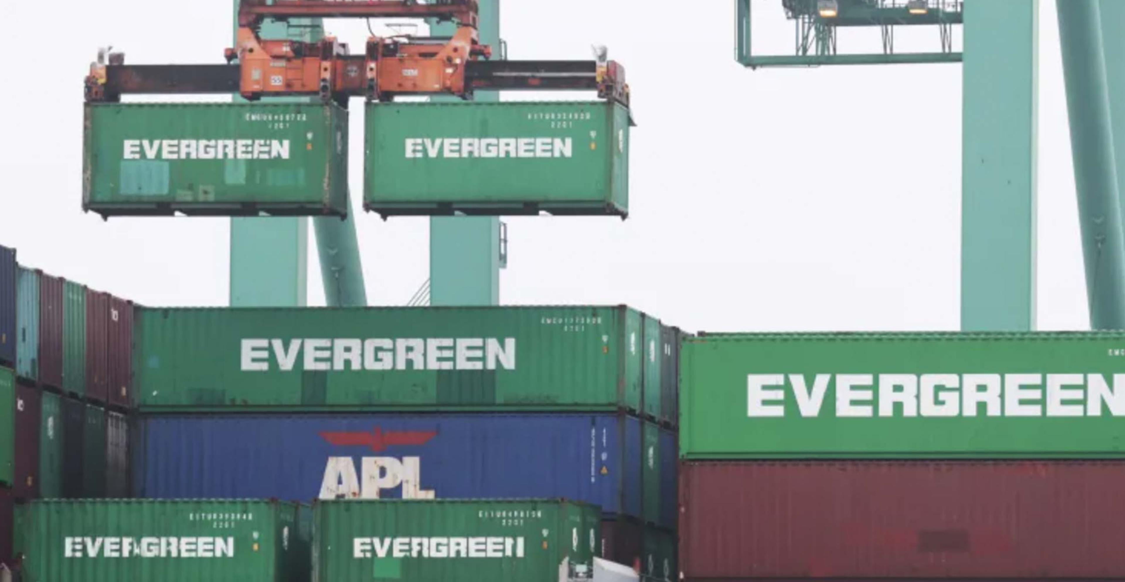 Evergreen shipping containers being unloaded in west coast ports