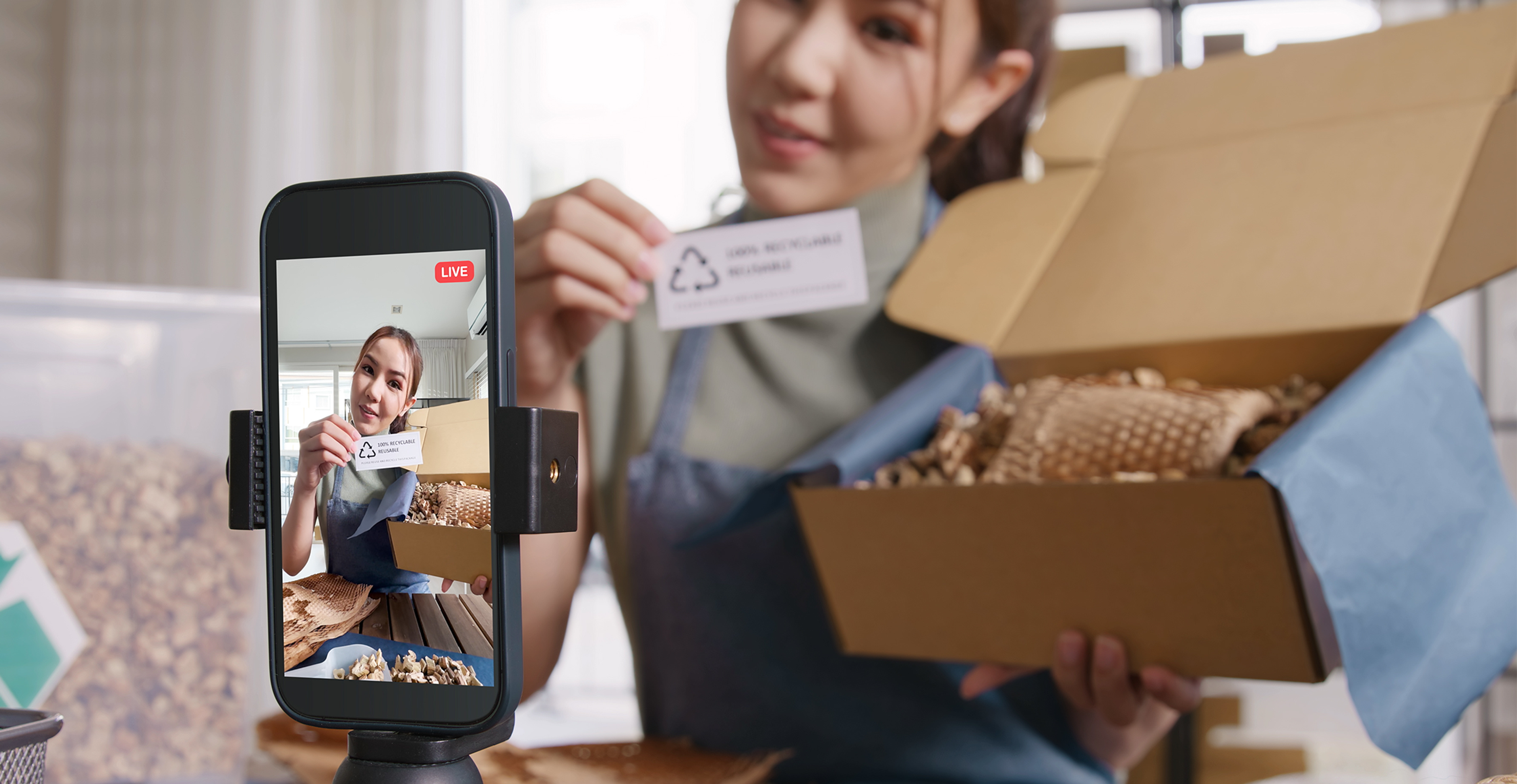 a woman recording an unboxing video of a viral product for social media