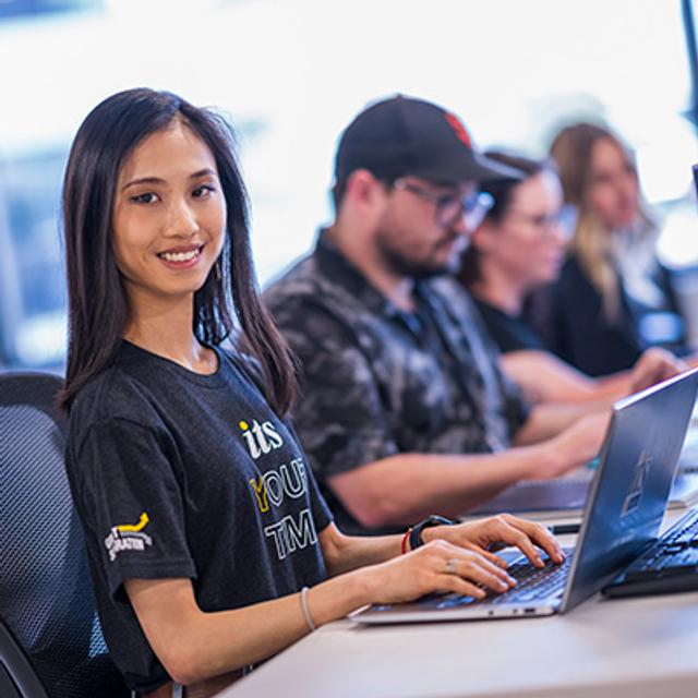 An ITS team member working on a computer