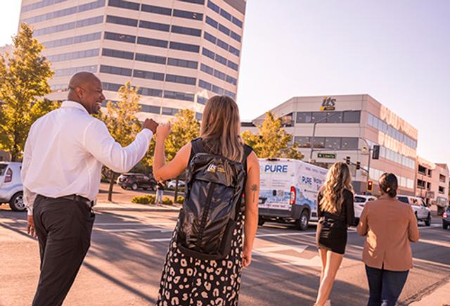 Two ITS team members fist bumping in front of the ITS Reno building