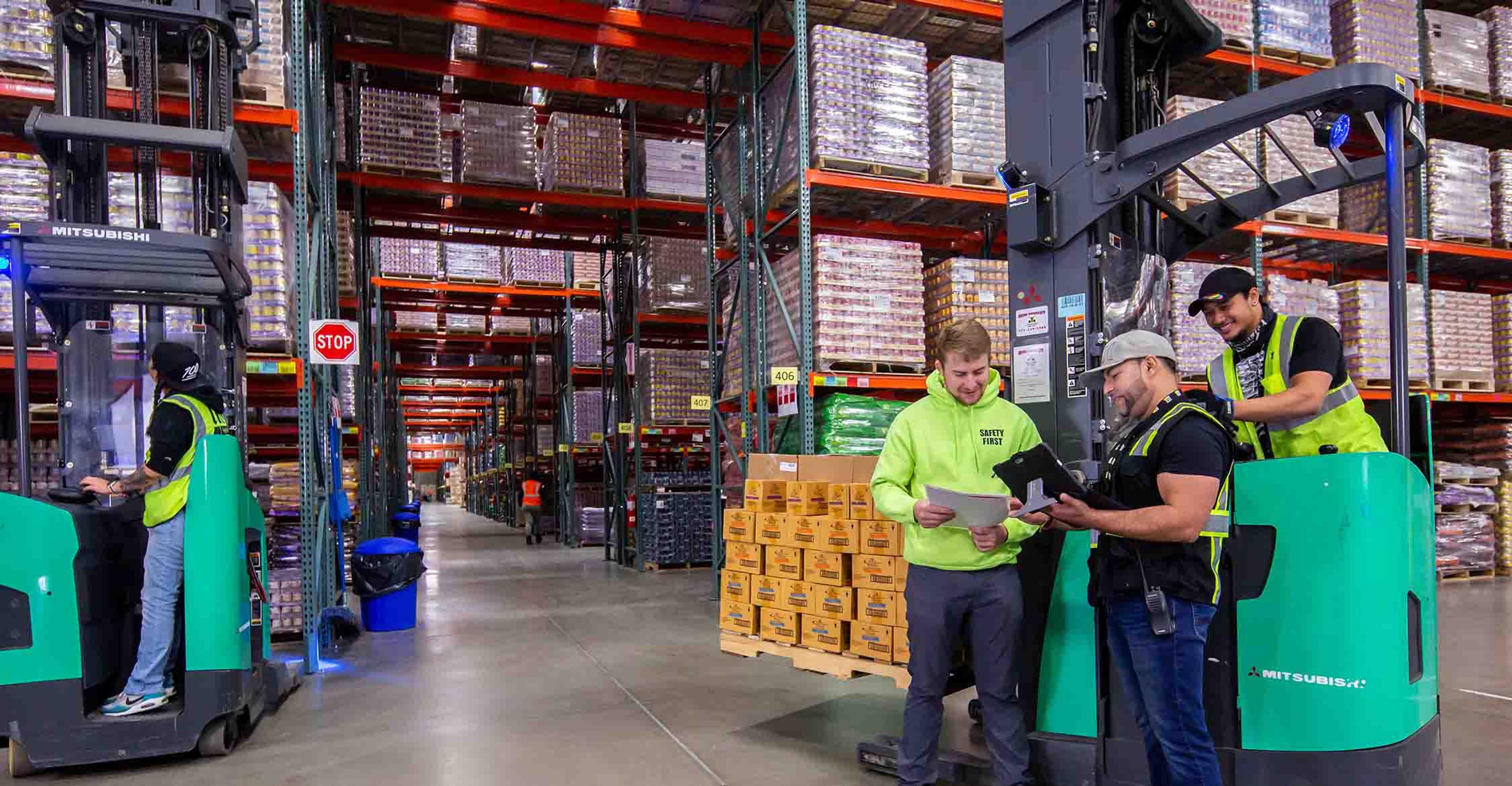 A group of ITS team members gathered around a forklift