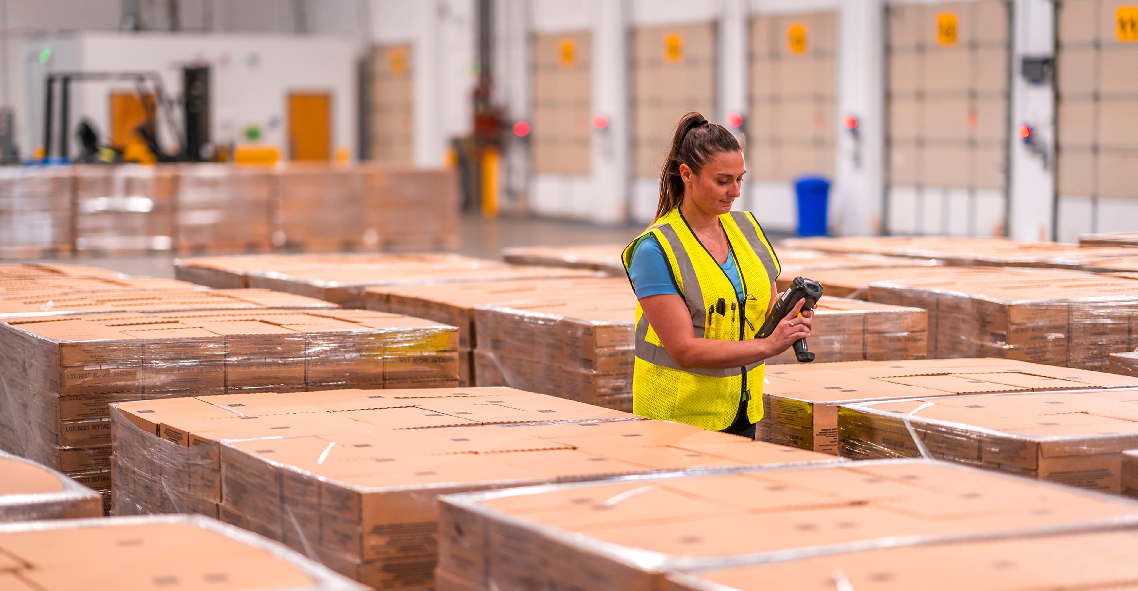 employee scanning inventory in warehouse