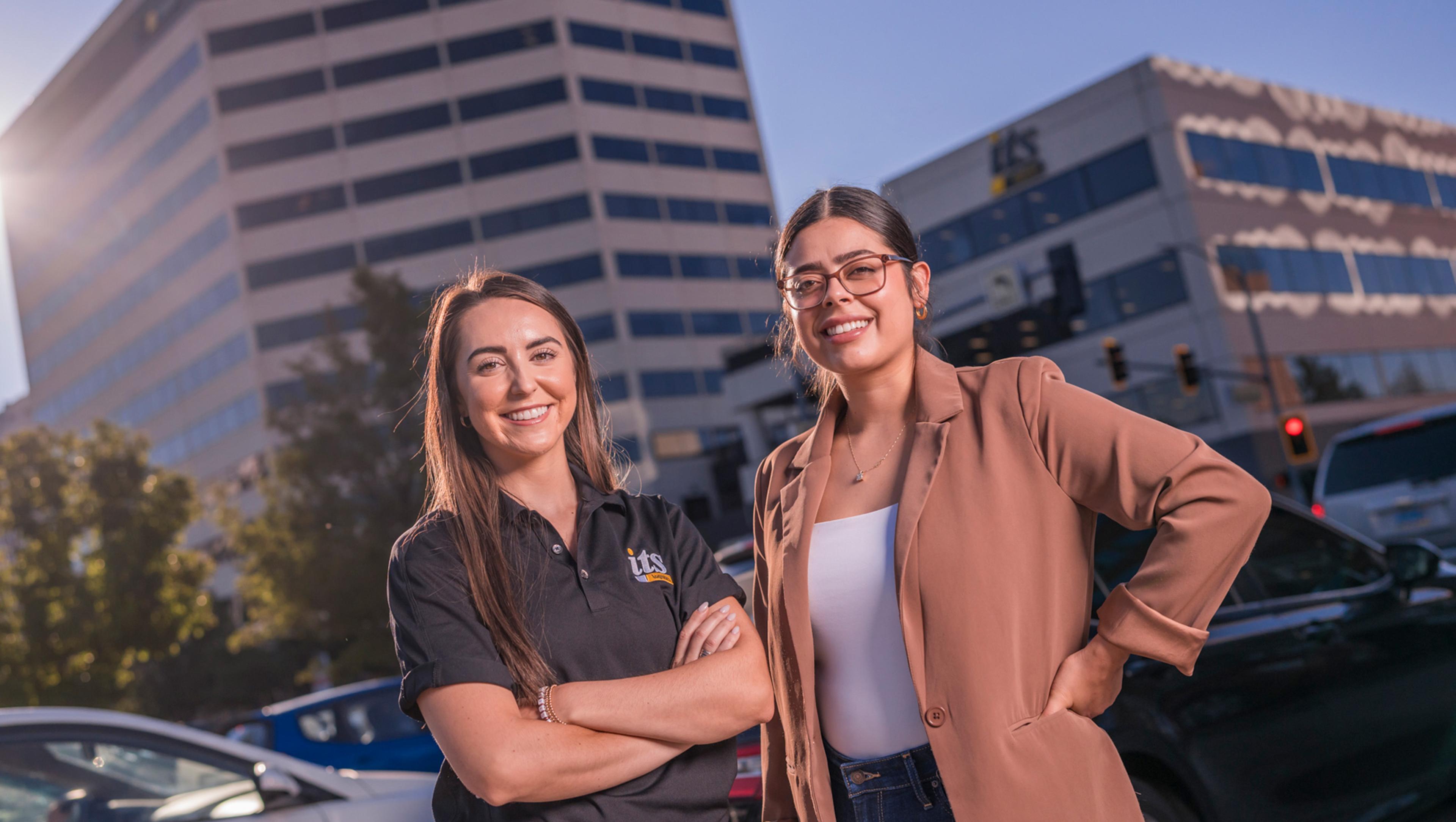 Two ITS team members in front of the Reno building