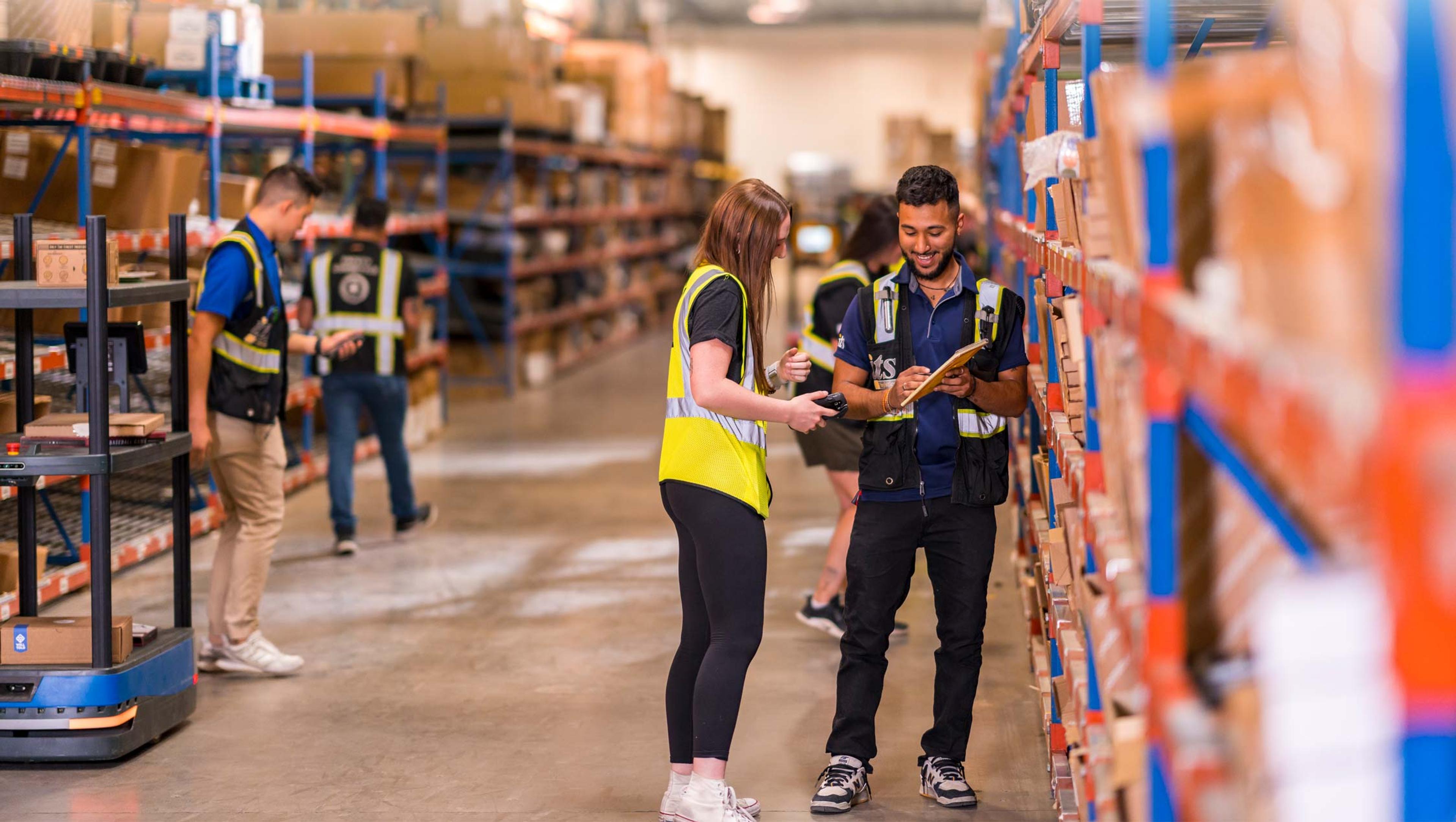 two warehouse workers going over inventory