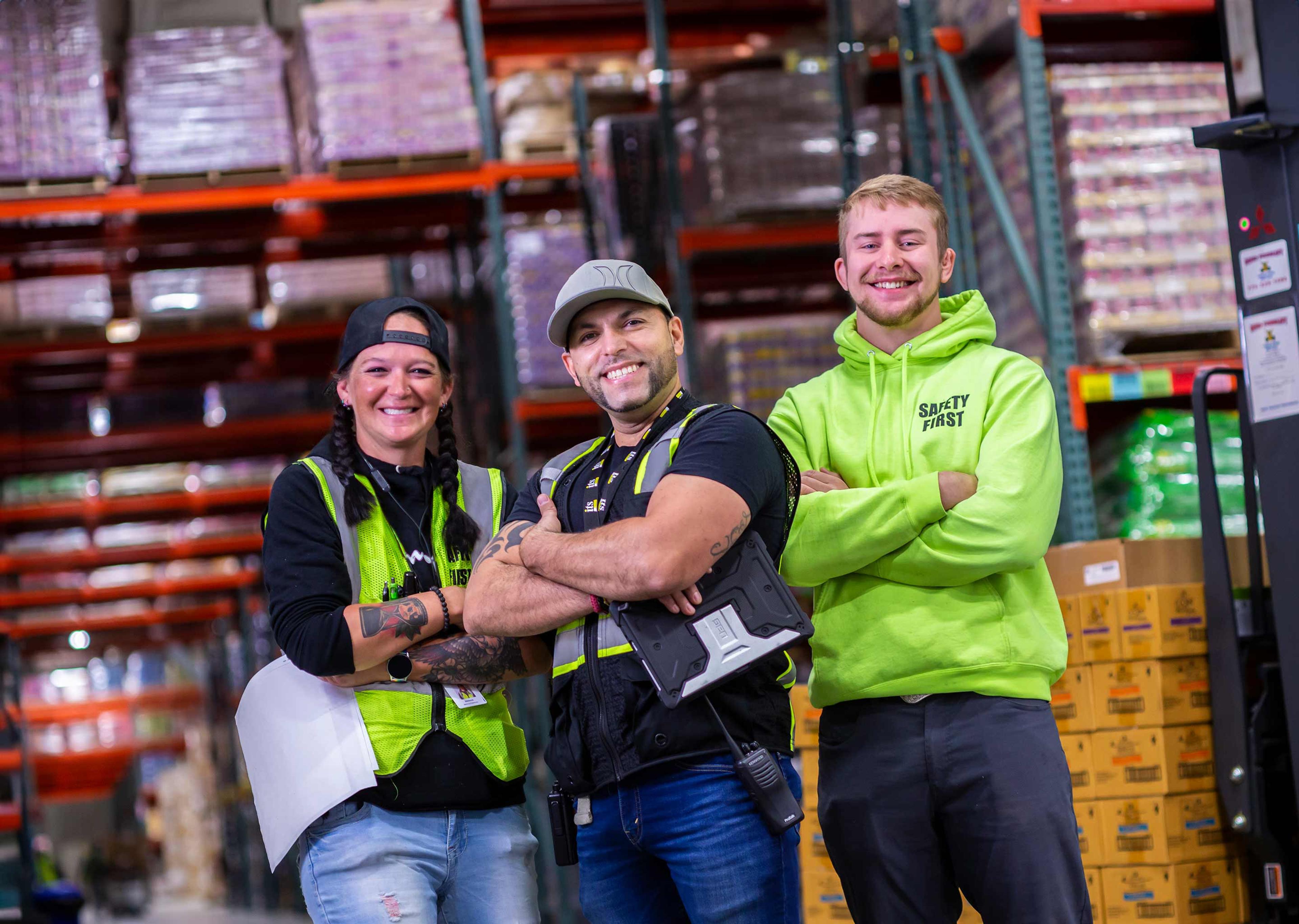 three warehouse worker employees