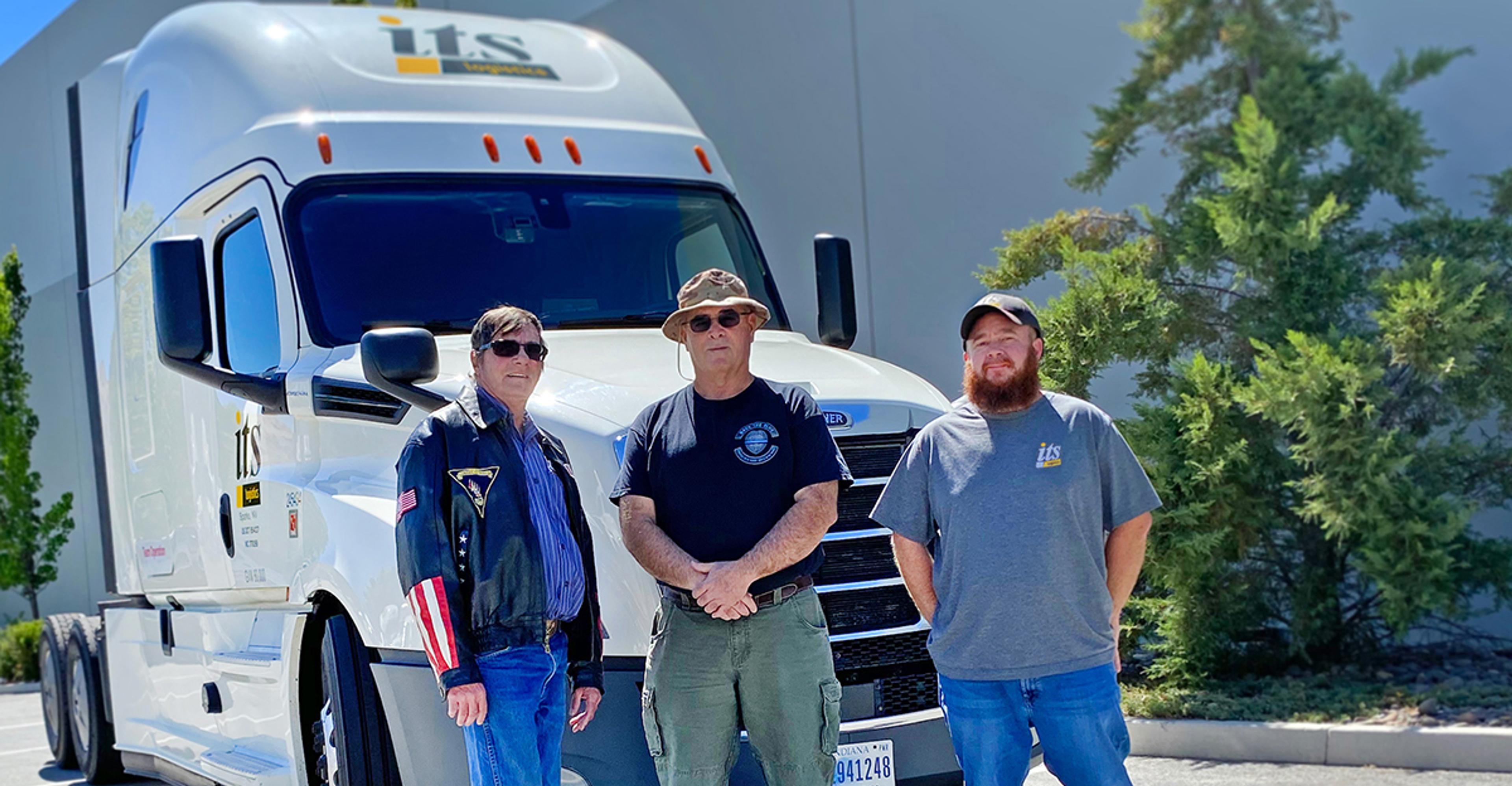 three veterans standing in front of ITS truck