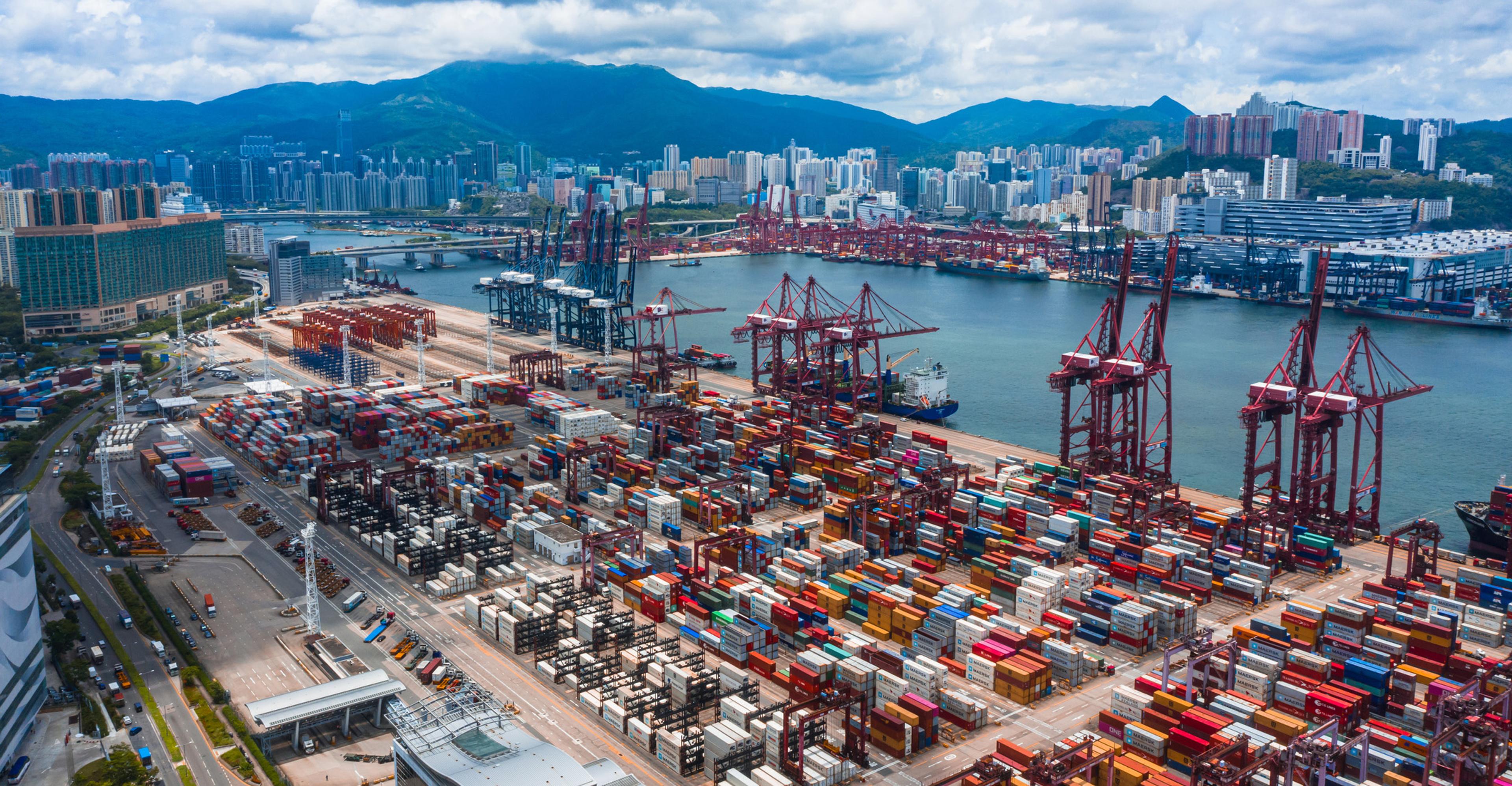 Aerial view of unloaded containers waiting at a port.