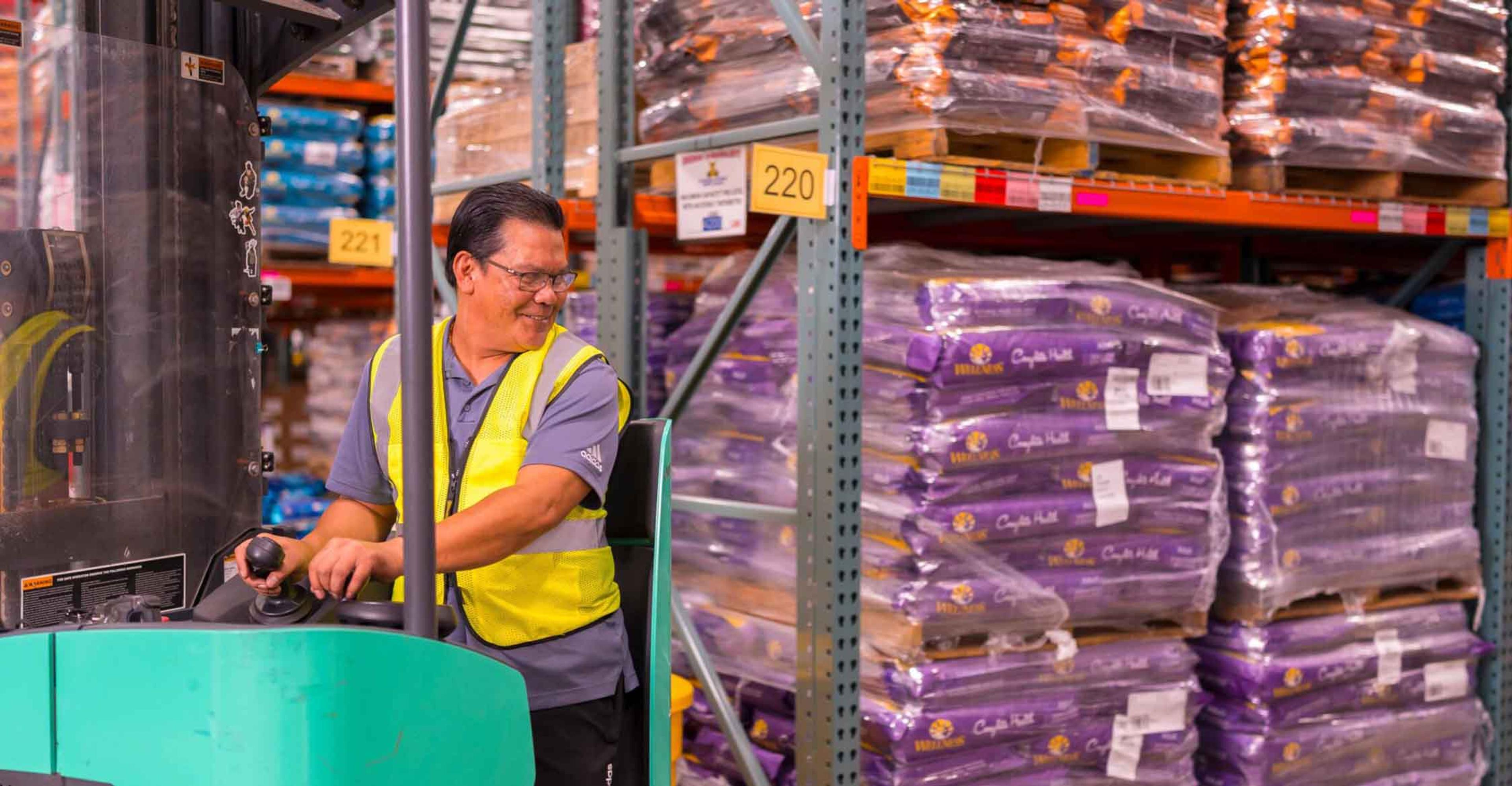 A warehousing team member operating a forklift