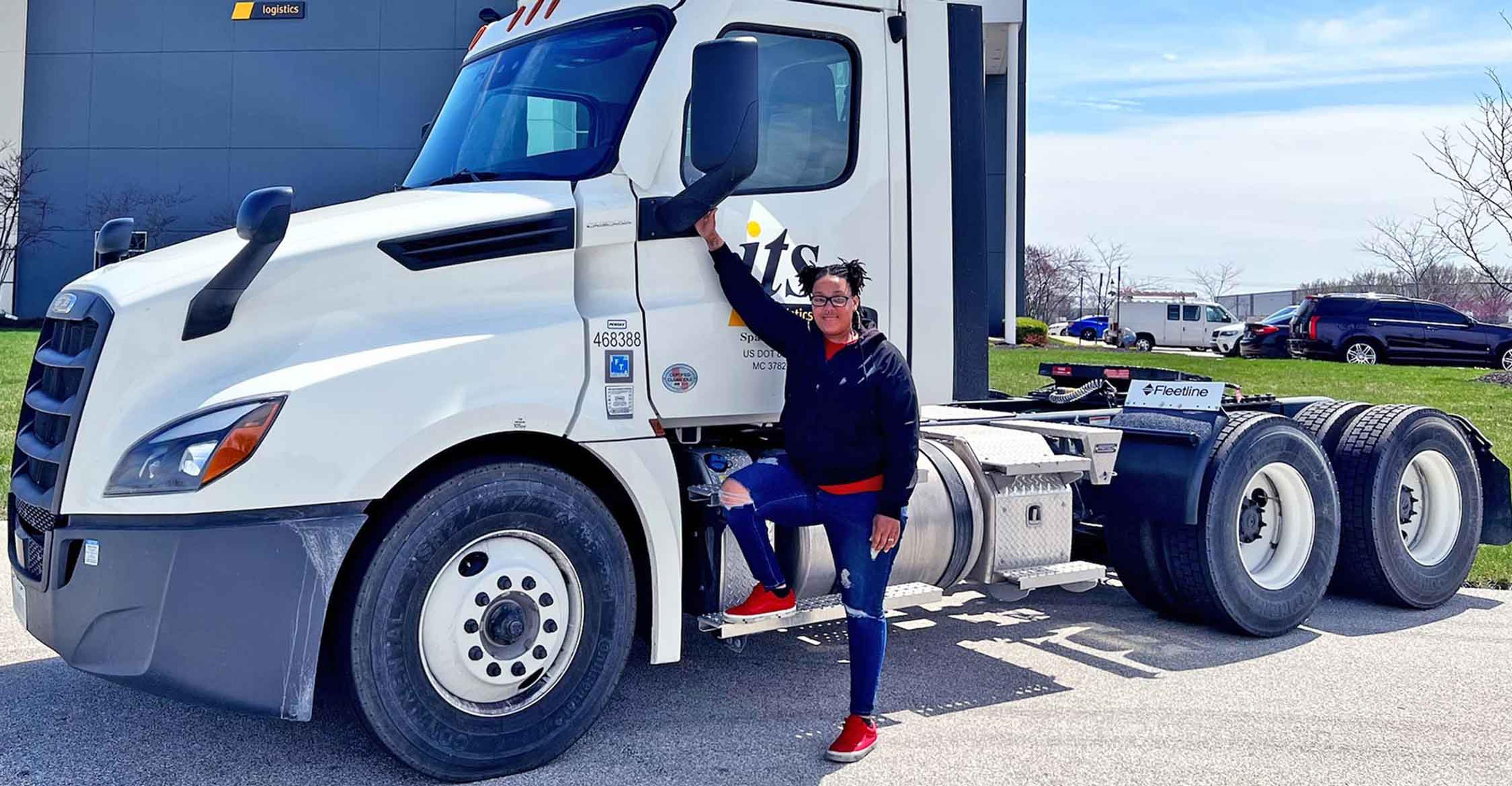 An ITS truck driver standing in front of an ITS truck