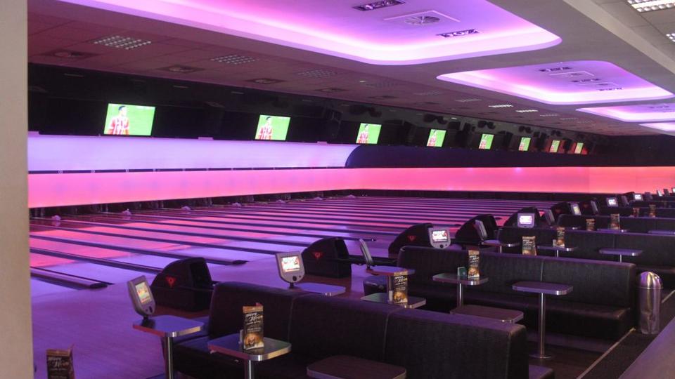 Bowling lanes and shared seating at Bowling Lounge MG.