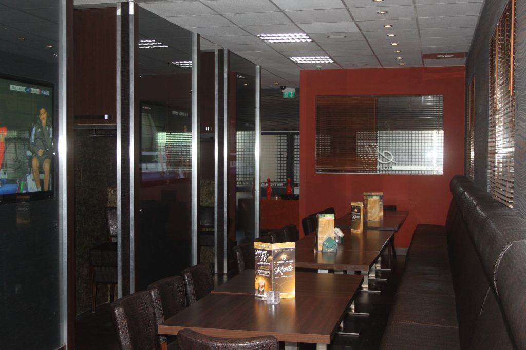 Sky Lounge seating with a sports screen.
