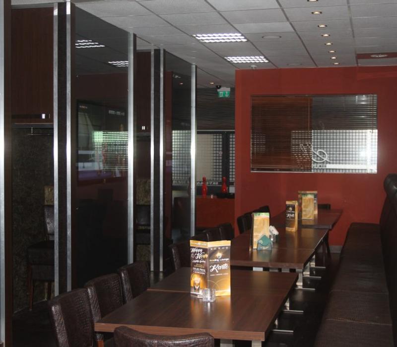Seating and a screen in the Sky Lounge.
