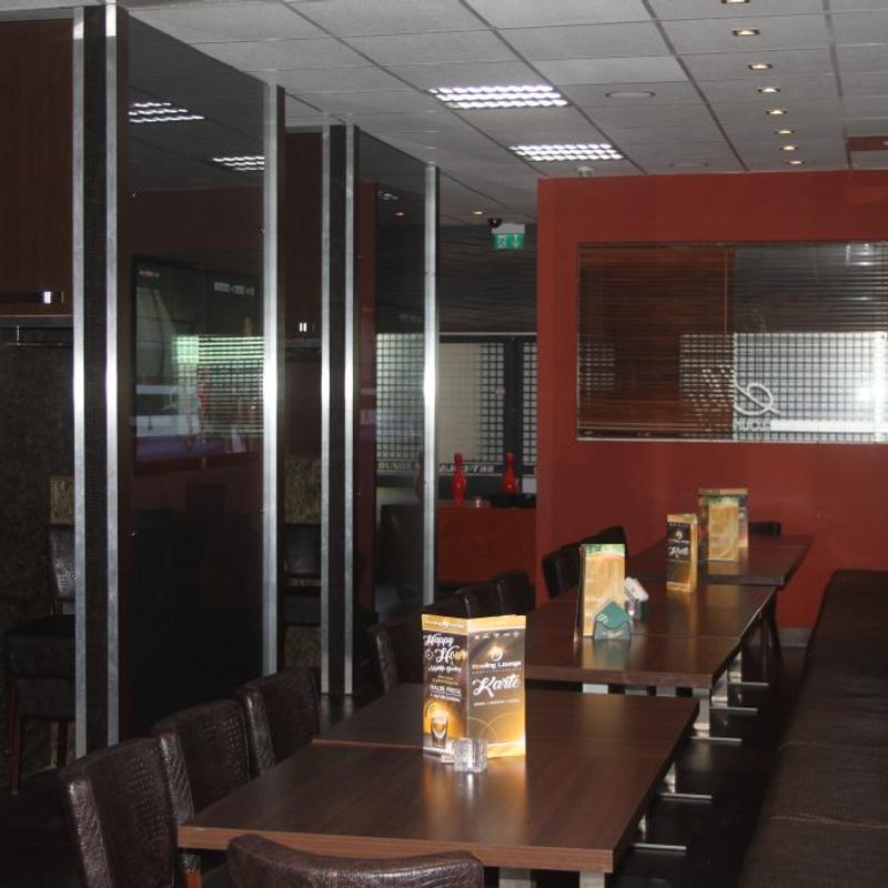 Seating with a sports screen in the Sky Lounge.