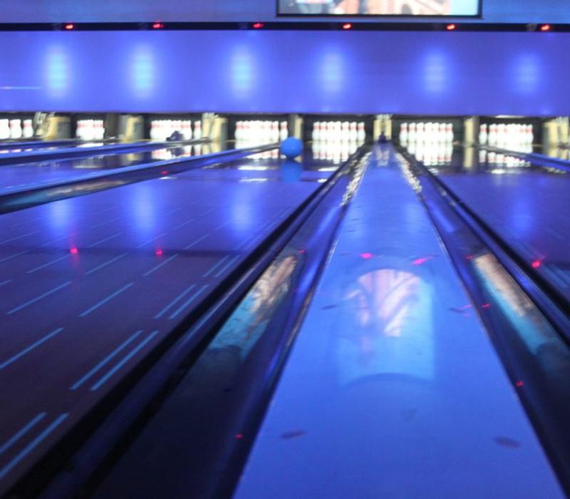Pins and illuminated bowling lanes.