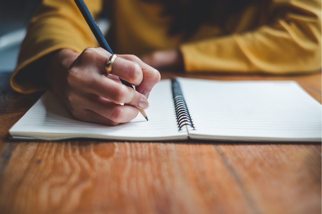 writing on notebook