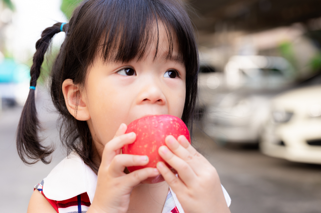 child eating apple