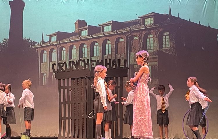 small children on stage at end of term school production