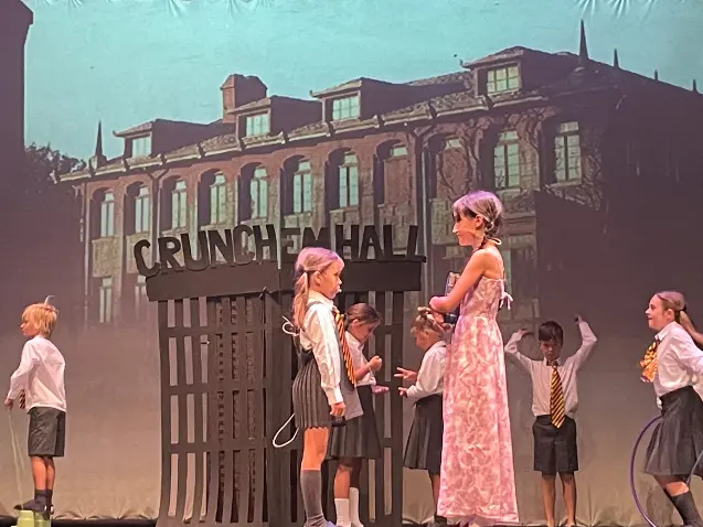 small children on stage at end of term school production