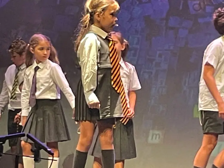 small girl on stage for end of school production
