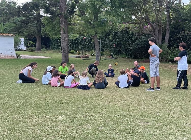 students sitting in circle for outdoor session