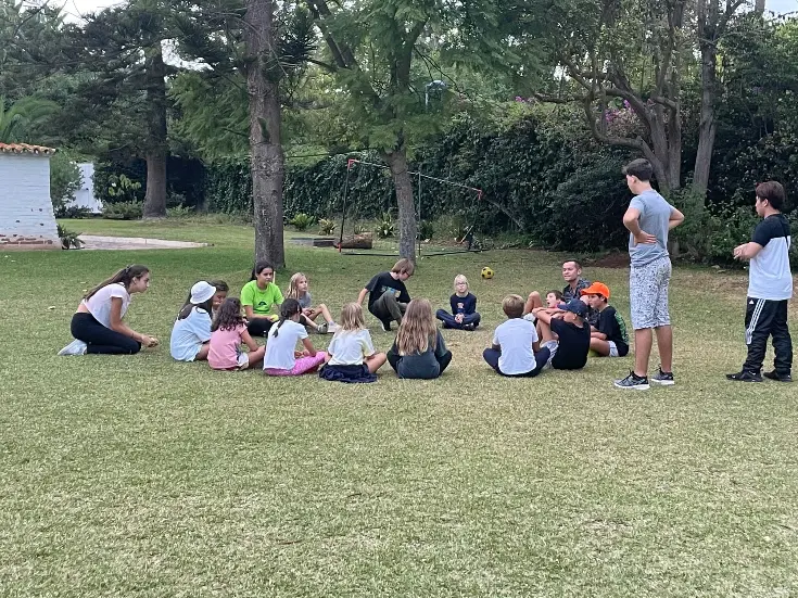 students sitting in circle for outdoor session