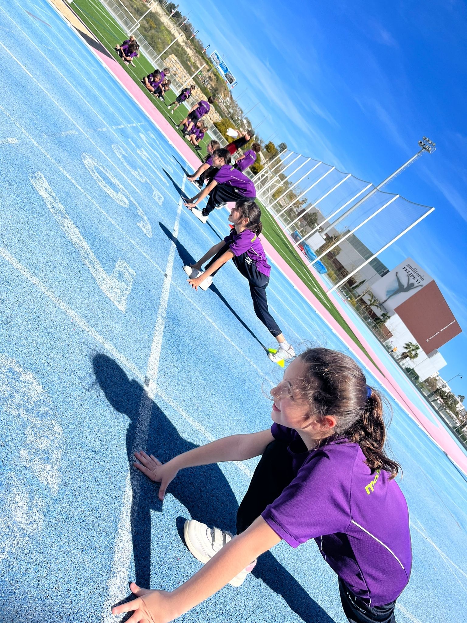 young girl getting ready to sprint at school sport day