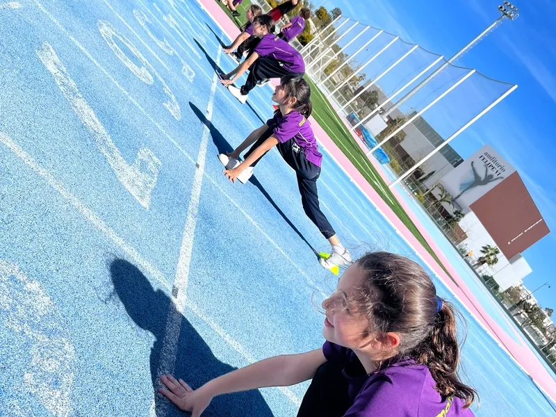 young girl getting ready to sprint at school sport day