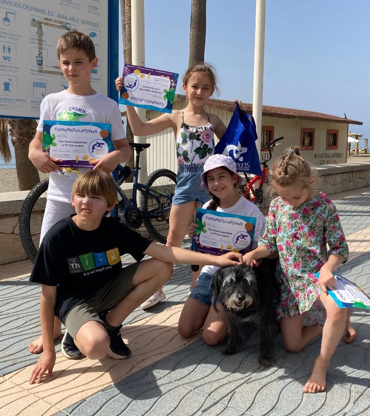 small children with schooldog being awarded with eco certificates