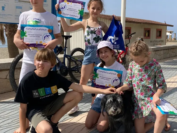 small children with schooldog being awarded with eco certificates