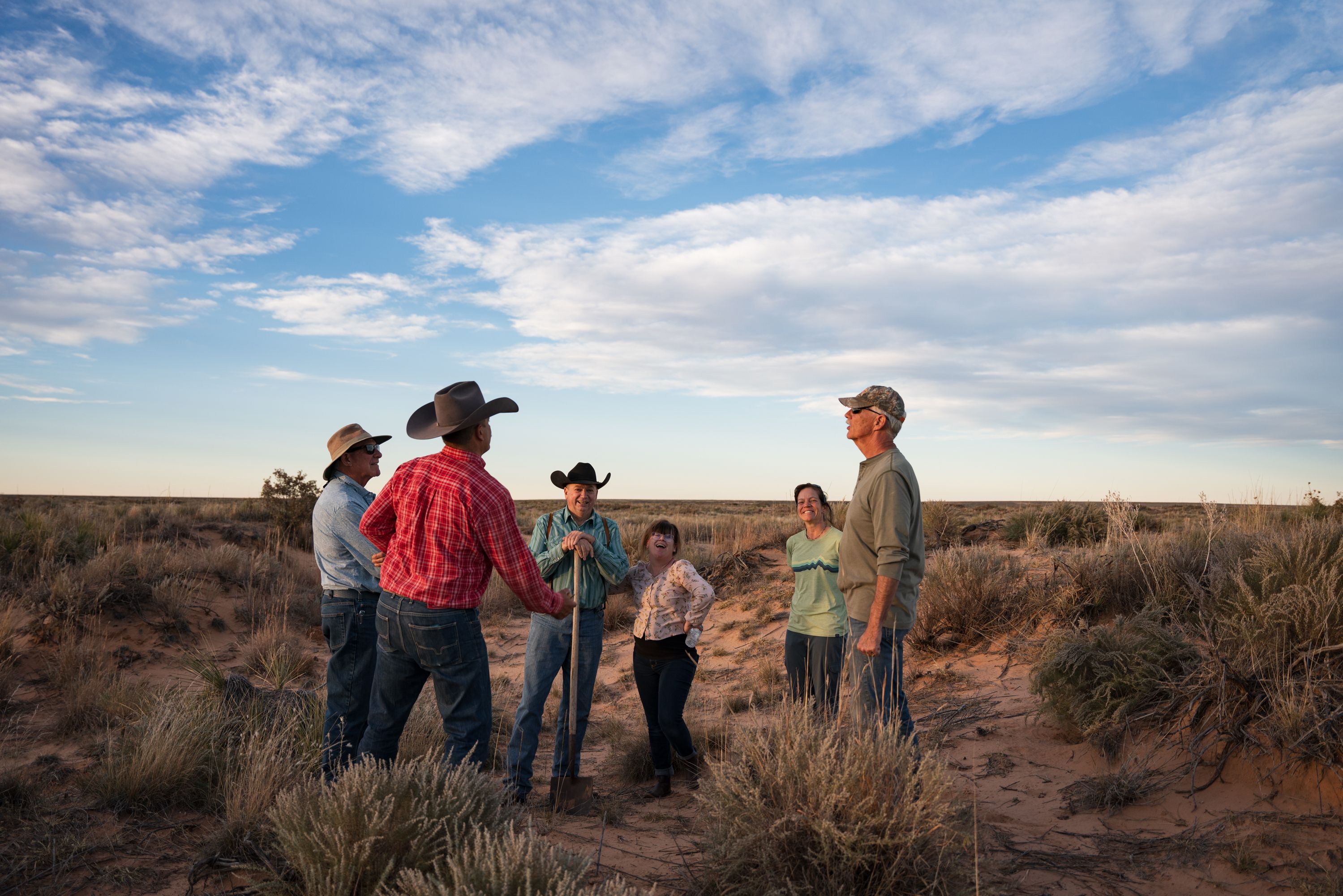 Ranchers and landowners talking together on open grassland