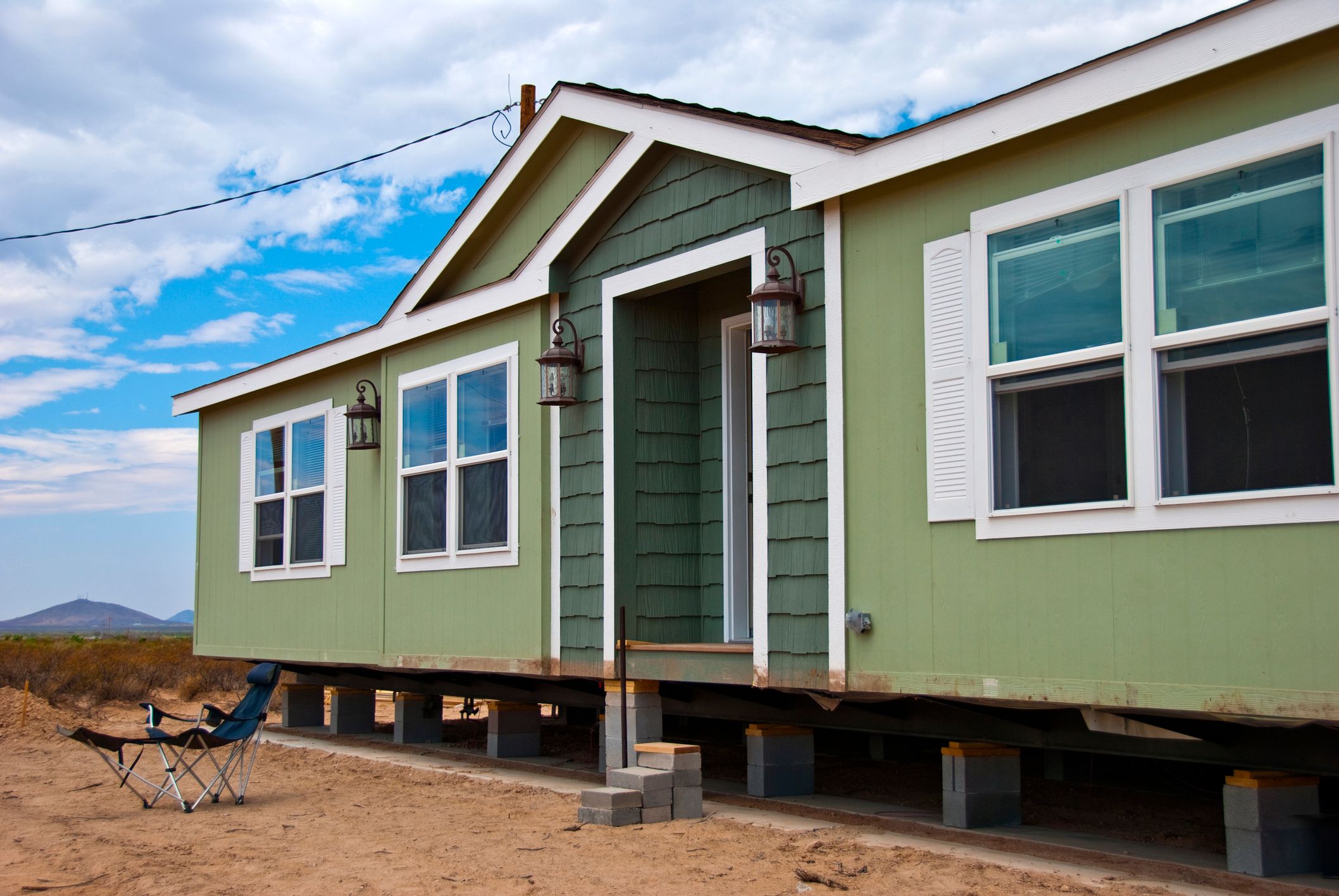 A manufactured home on temporary supports in rural New Mexico