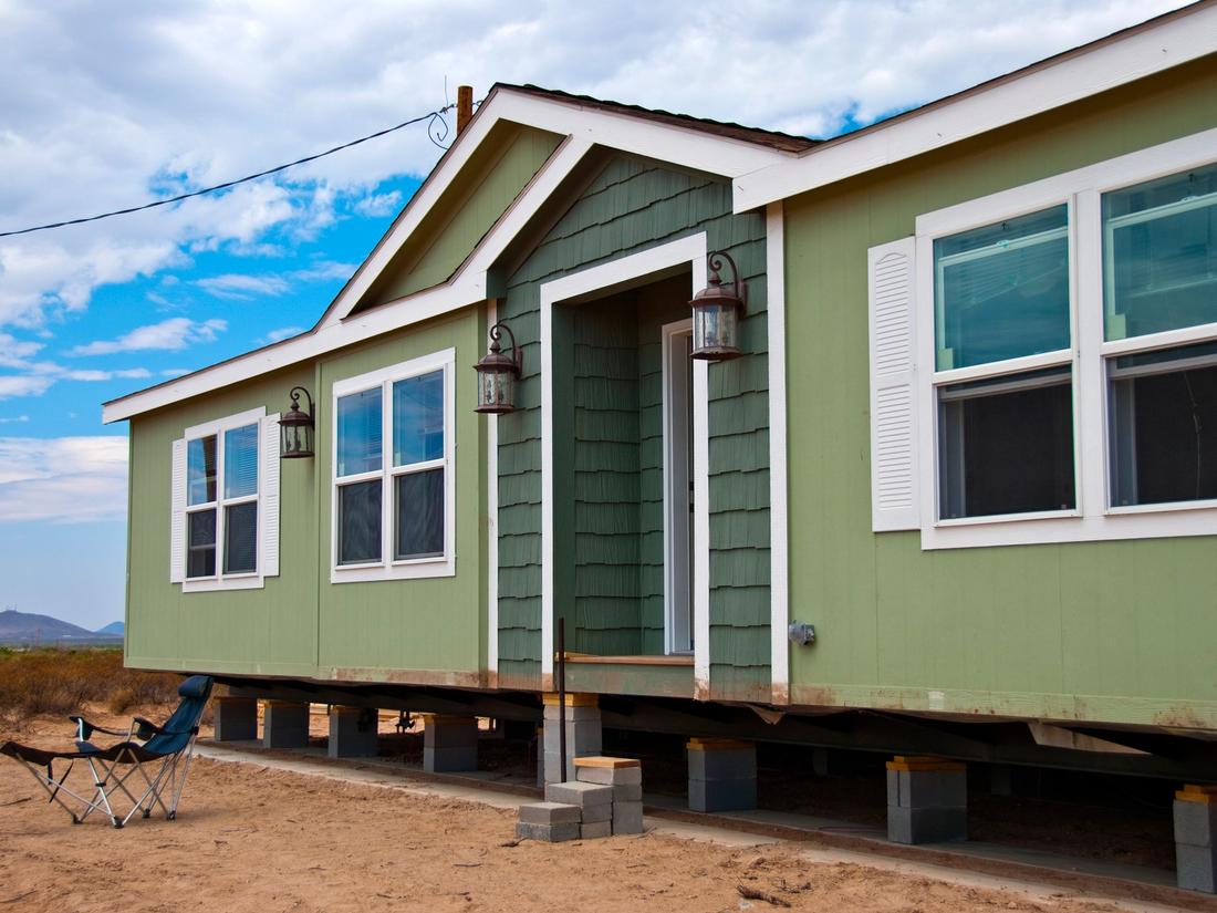 A manufactured home on temporary supports in rural New Mexico