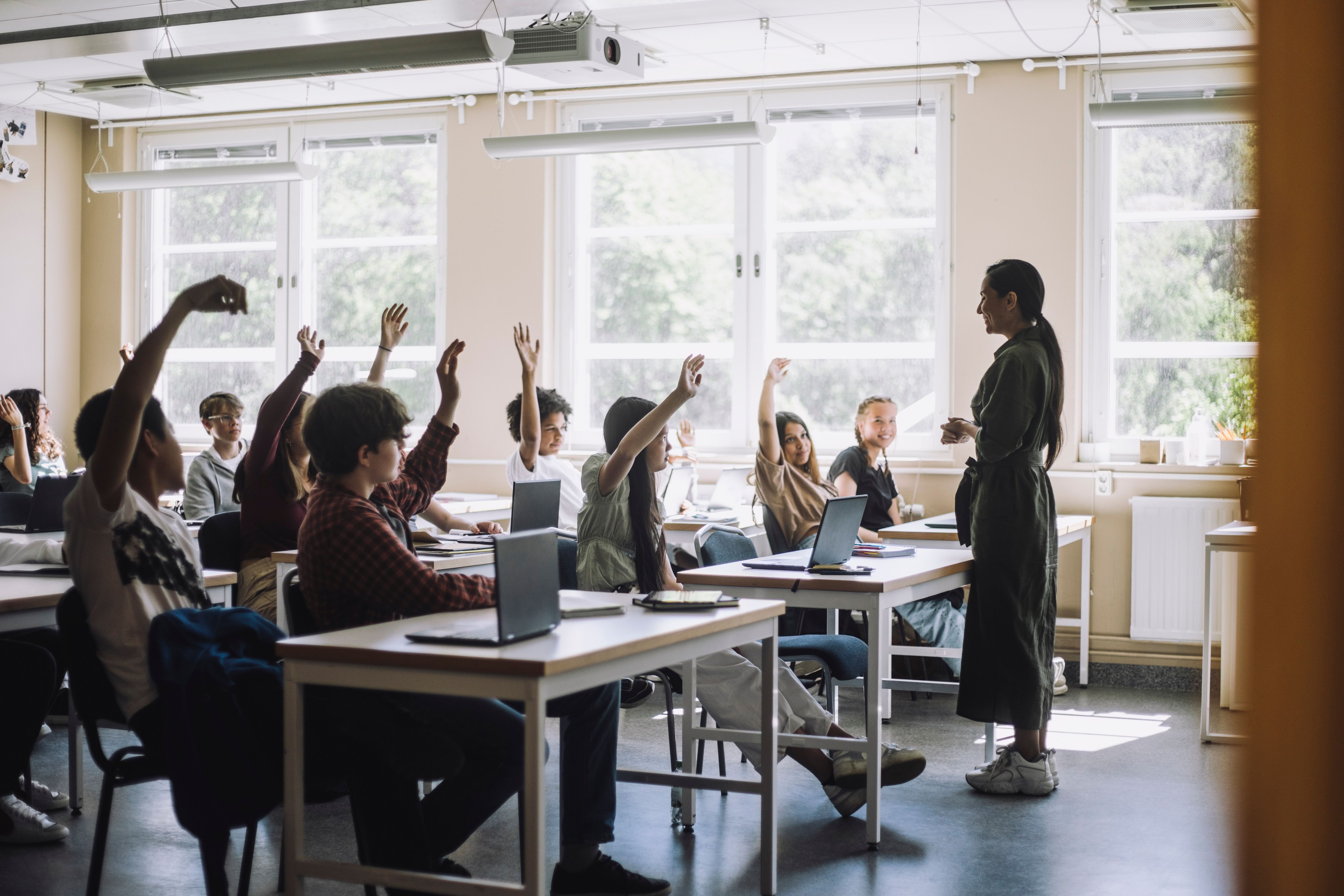 Students raising their hands during a lesson