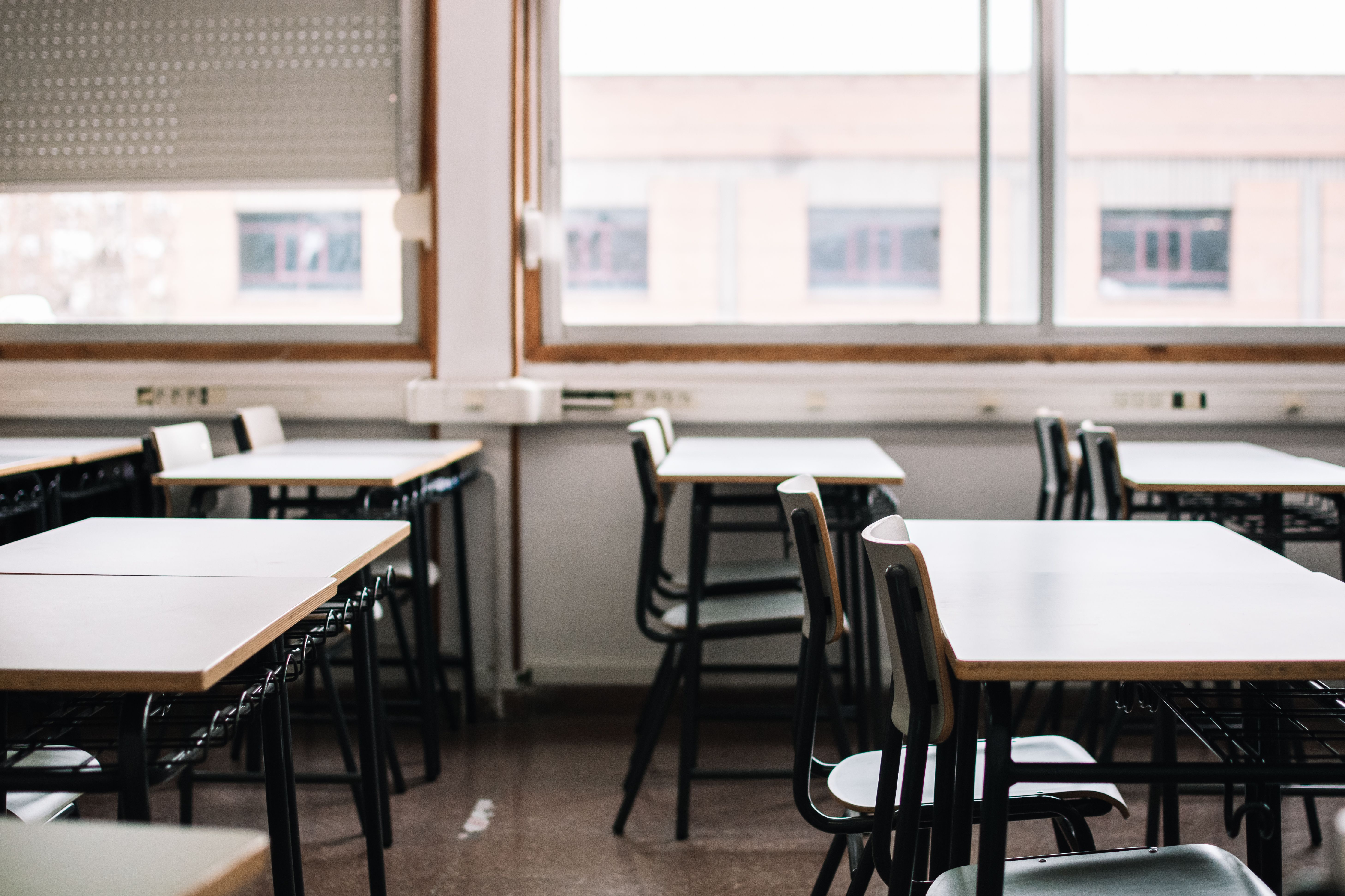 An empty classroom with desks and chairs