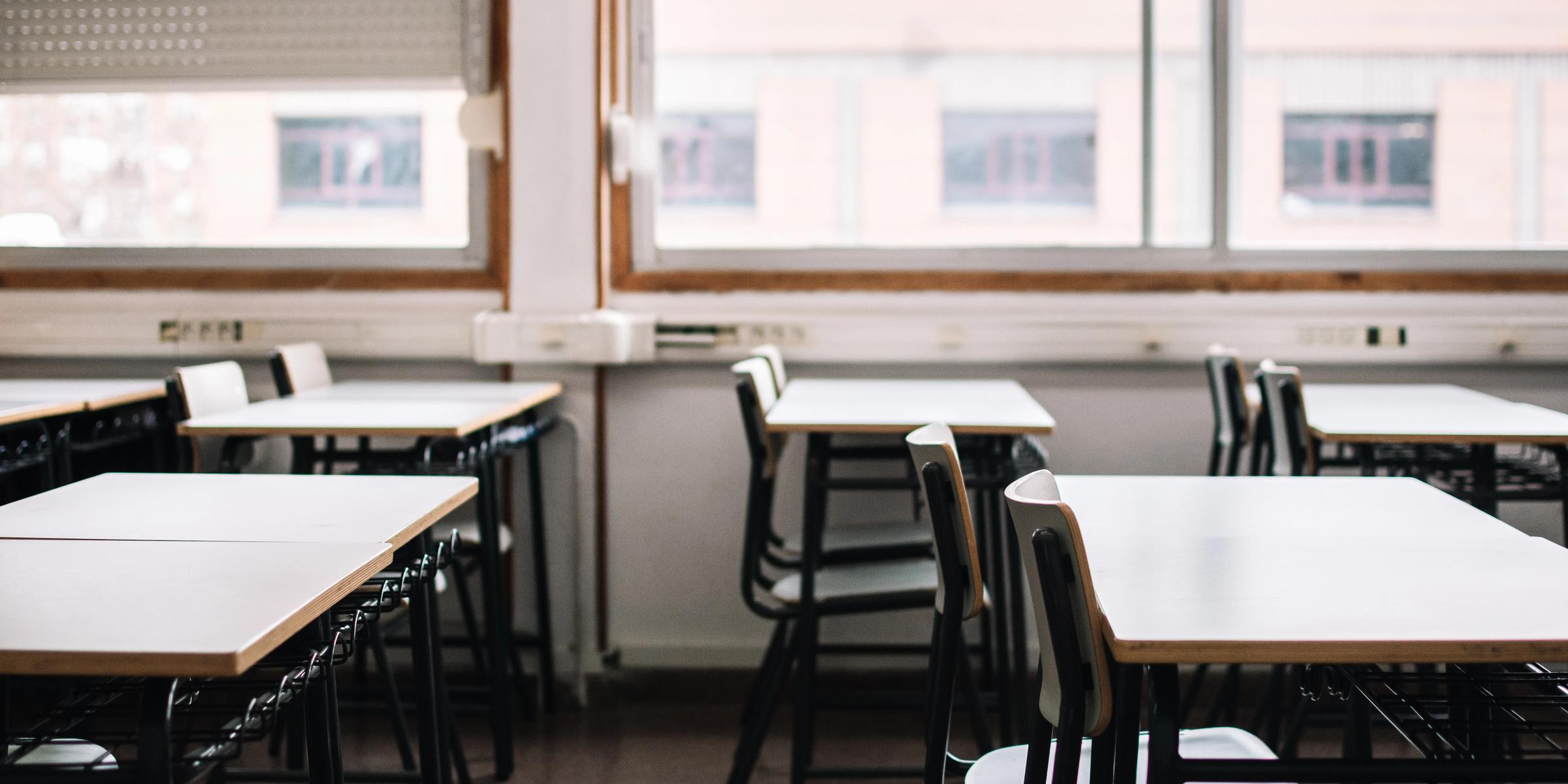 An empty classroom with desks and chairs