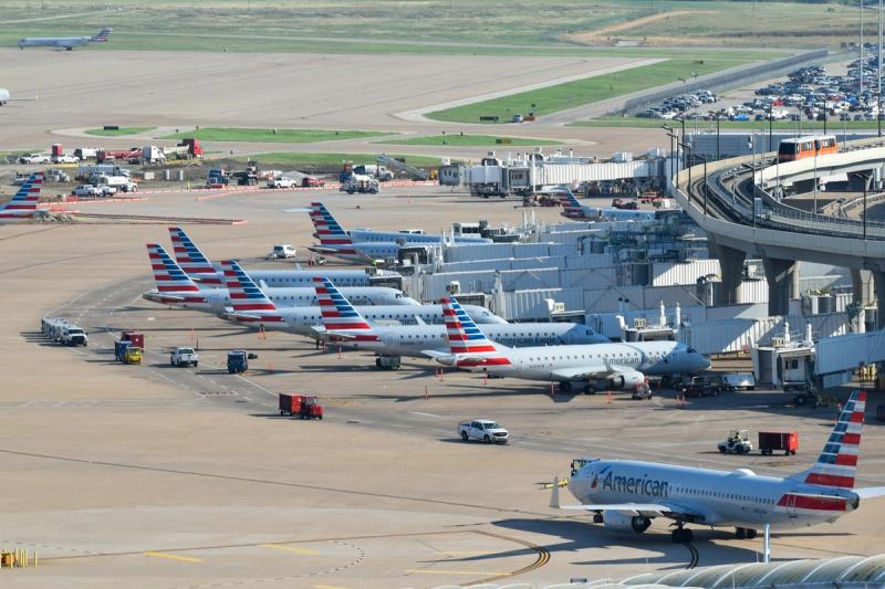 An airport apron with planes sat on the tarmac