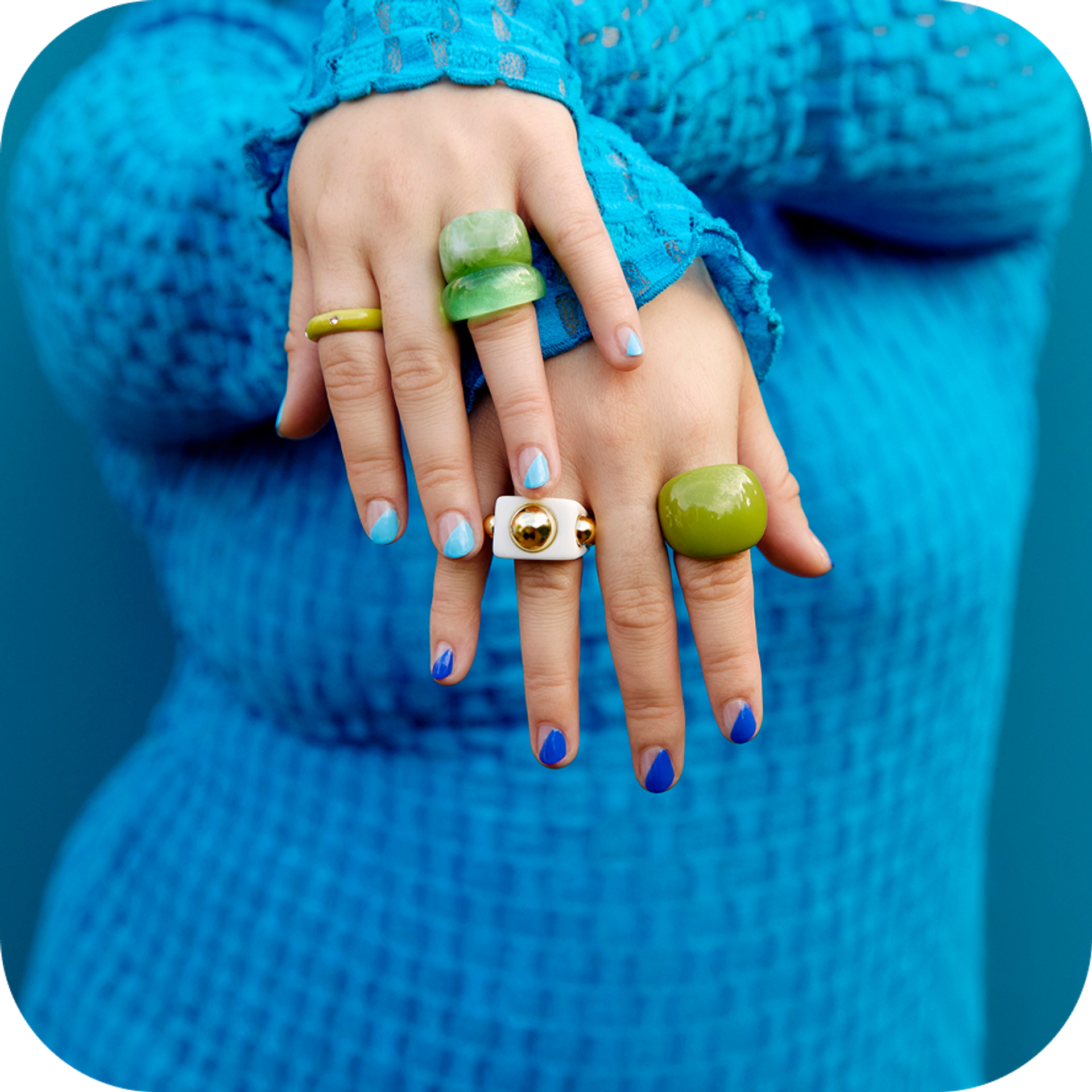Woman dressed in blue showing her rings 